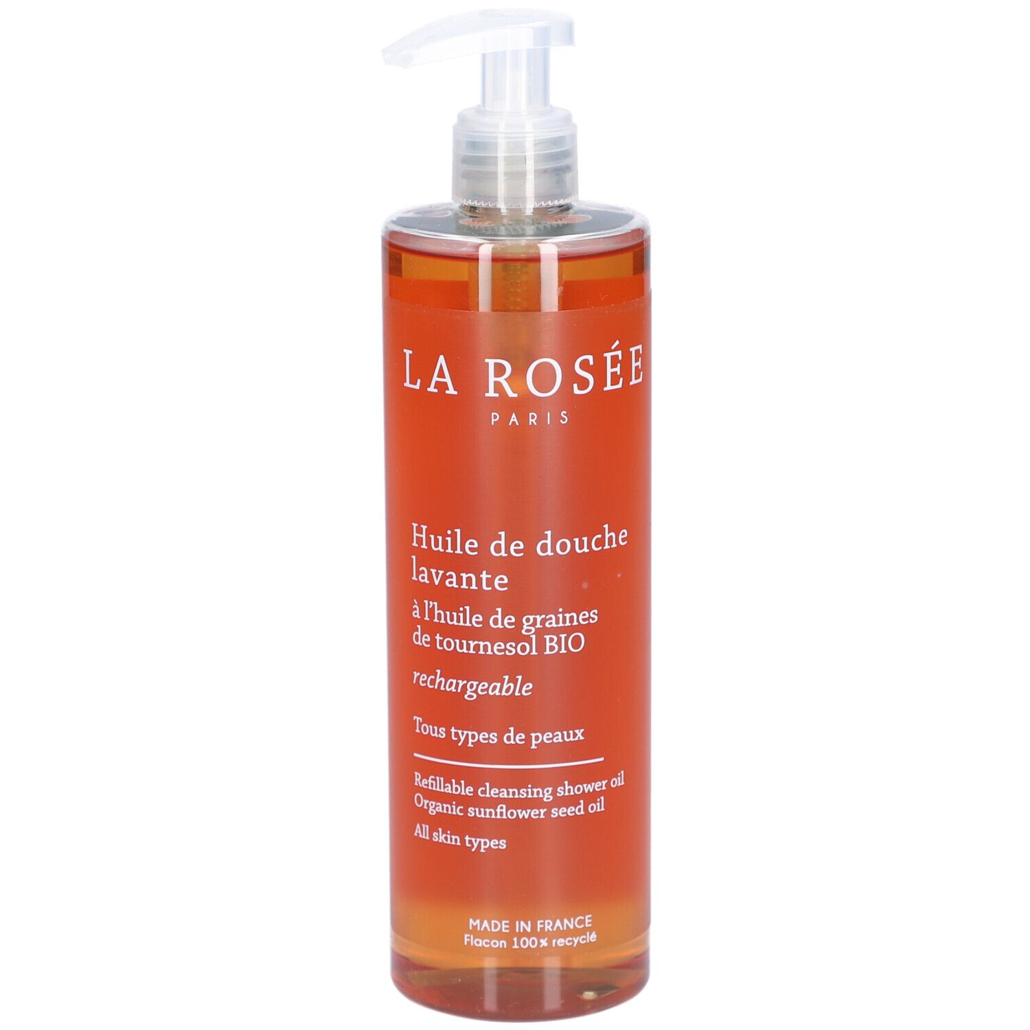 Transparante fles met oranje vloeistof en doseerpomp. Opschrift: La Rosée, Huile de douche lavante.