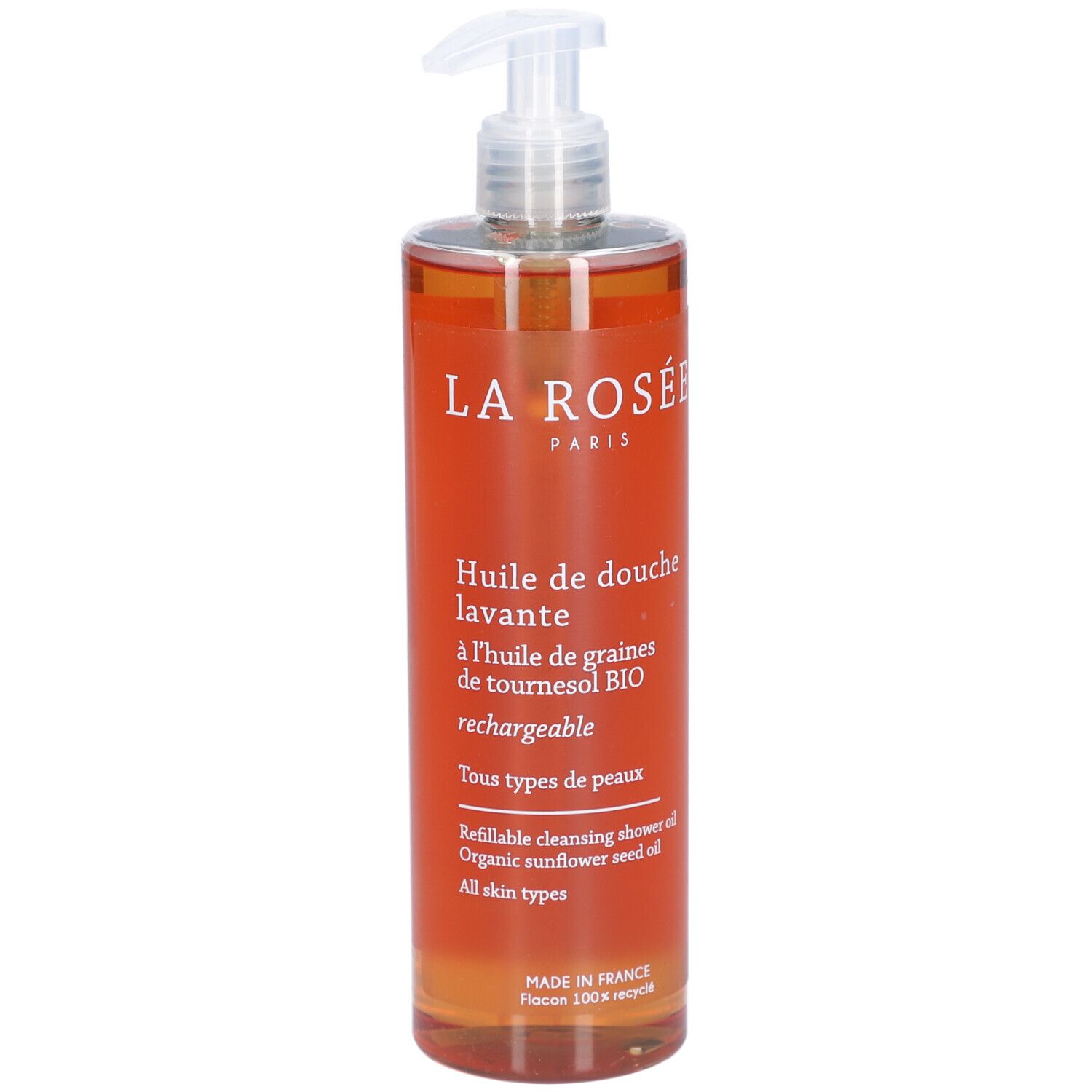 Transparante fles met oranje vloeistof en doseerpomp. Opschrift: La Rosée, Huile de douche lavante.