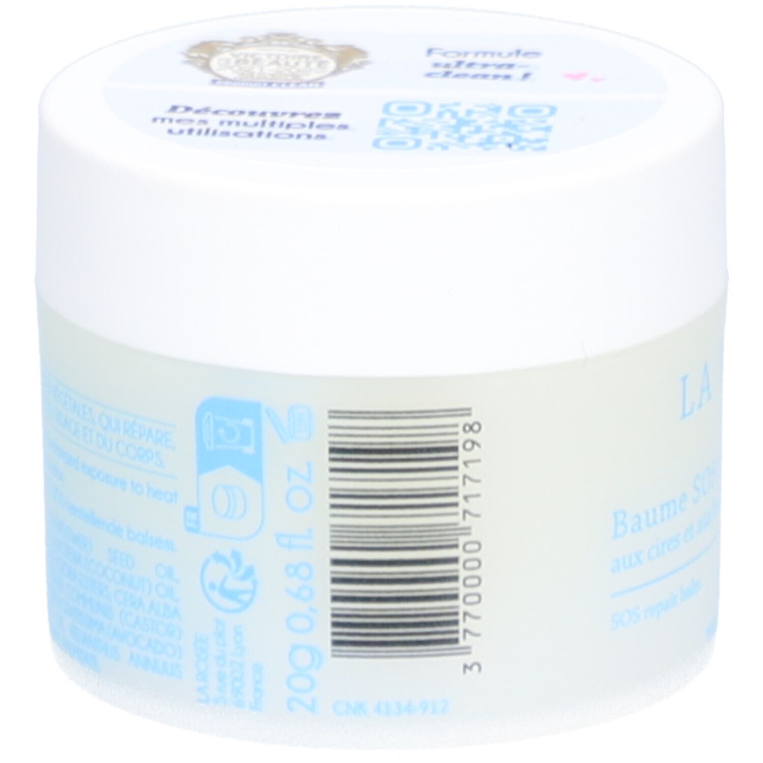 Cilindervormige pot met witte deksel. Streepjescode en tekst op de zijkant. Opschrift: 20g 0,68 fl. oz. Blauwe symbolen en tekst.