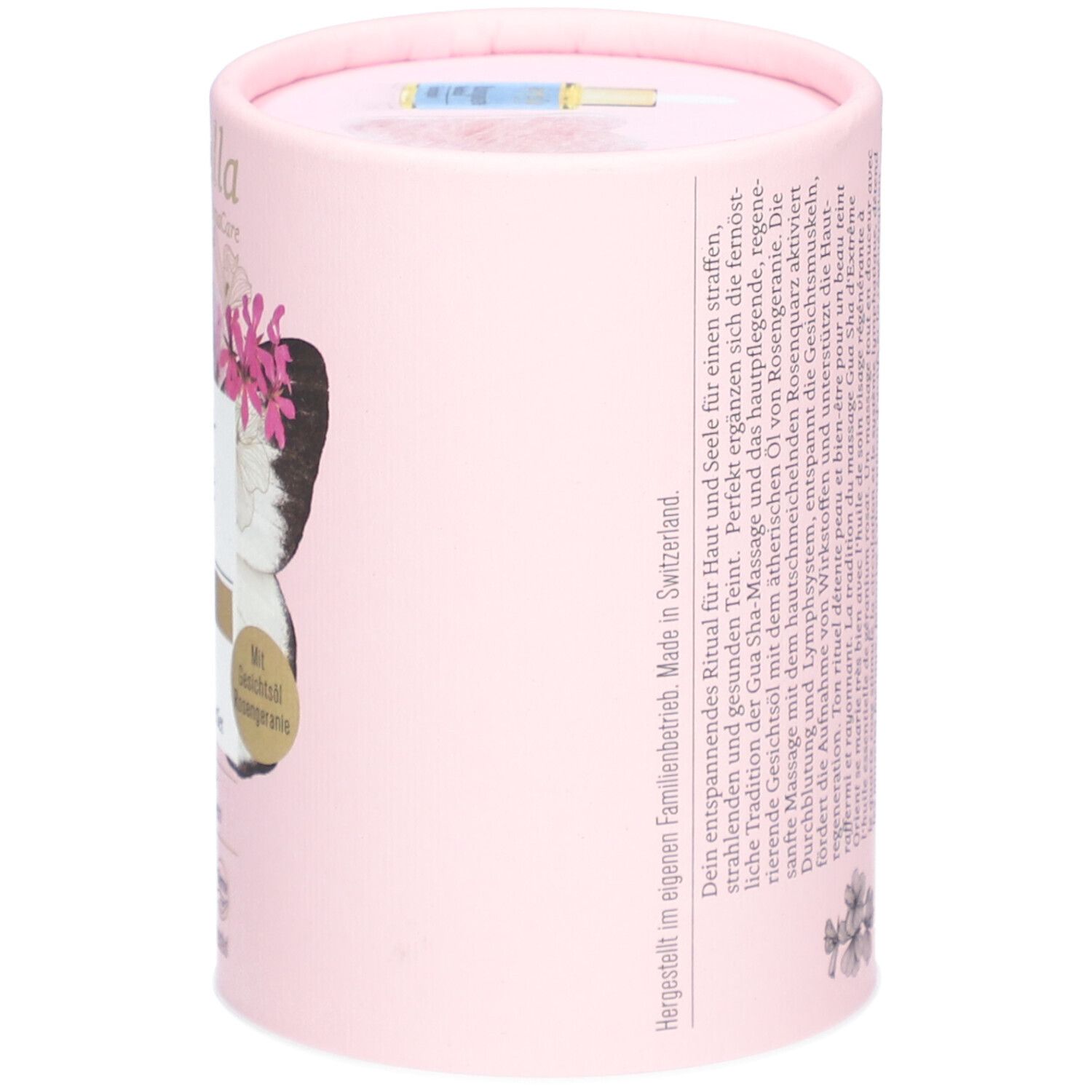 Roze cilindrische verpakking. Tekstfragmenten in het Duits en Frans. Met bloemenontwerp en logo.