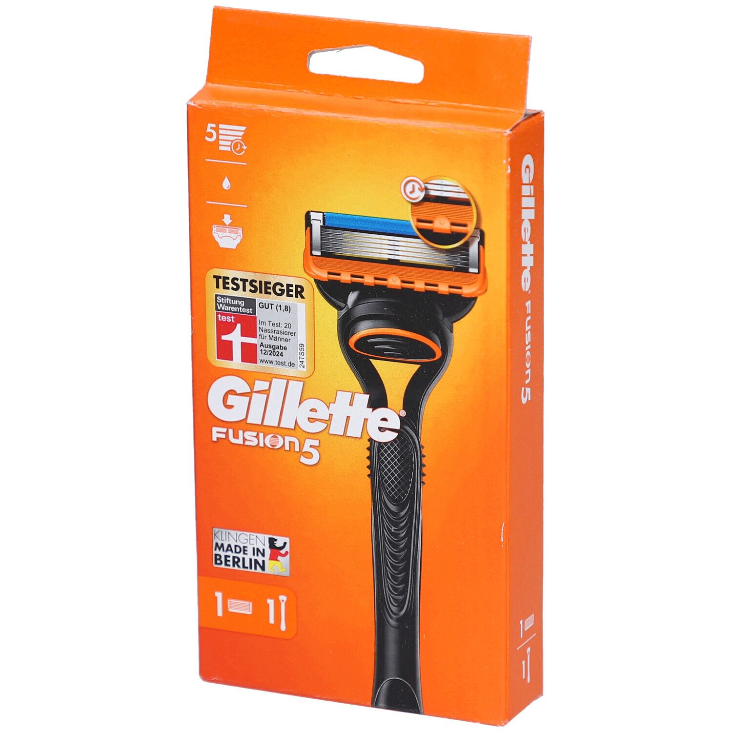Rasoir dans un emballage orange. Manche noir, tête orange avec lame bleue. Texte: Gillette Fusion5, TestSieger.