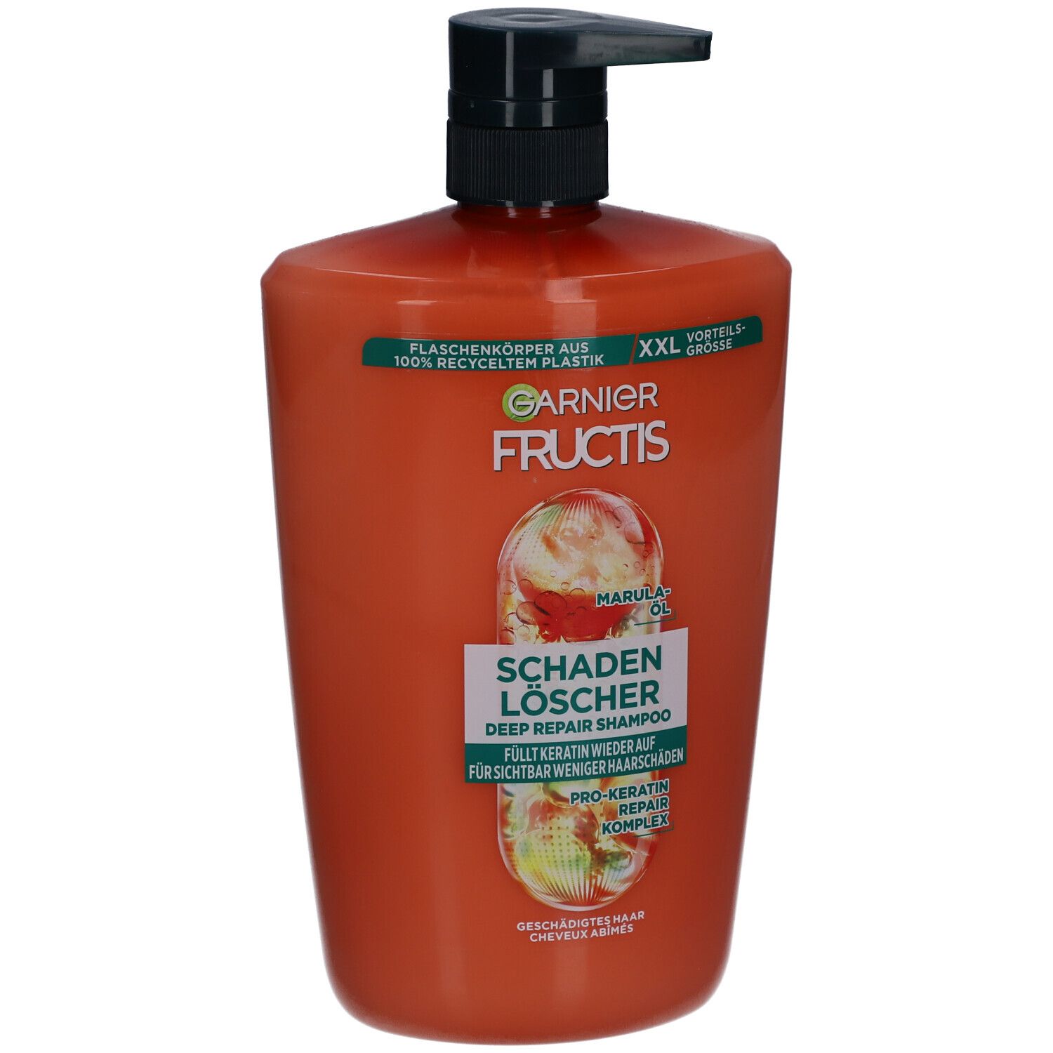 Oranje shampoo fles met zwarte pomp. Opschrift: Garnier Fructis, Schadenlöscher, Marula Oil.