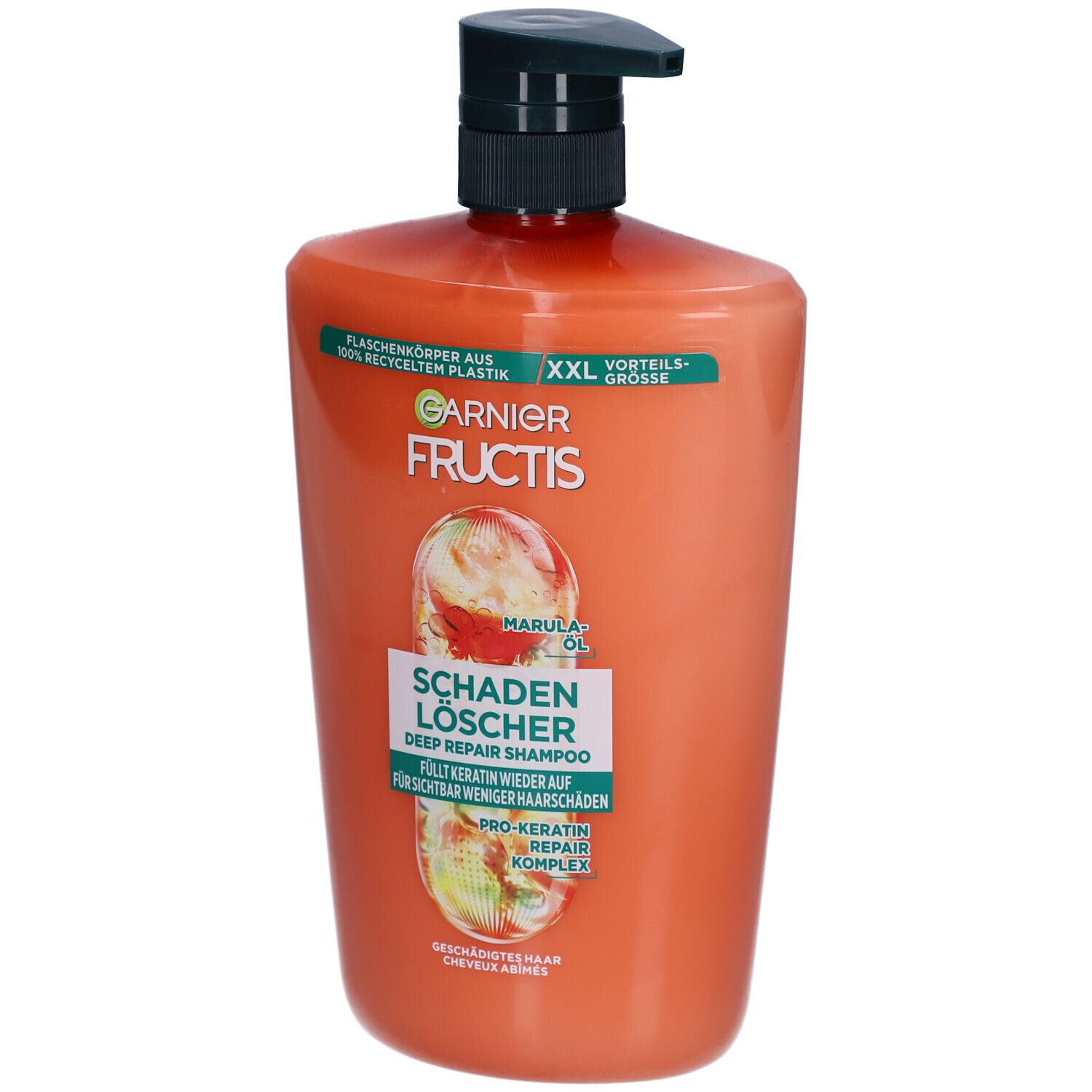 Oranje shampoo fles met zwarte pomp. Opschrift: Garnier Fructis, Schadenlöscher, Marula Oil.