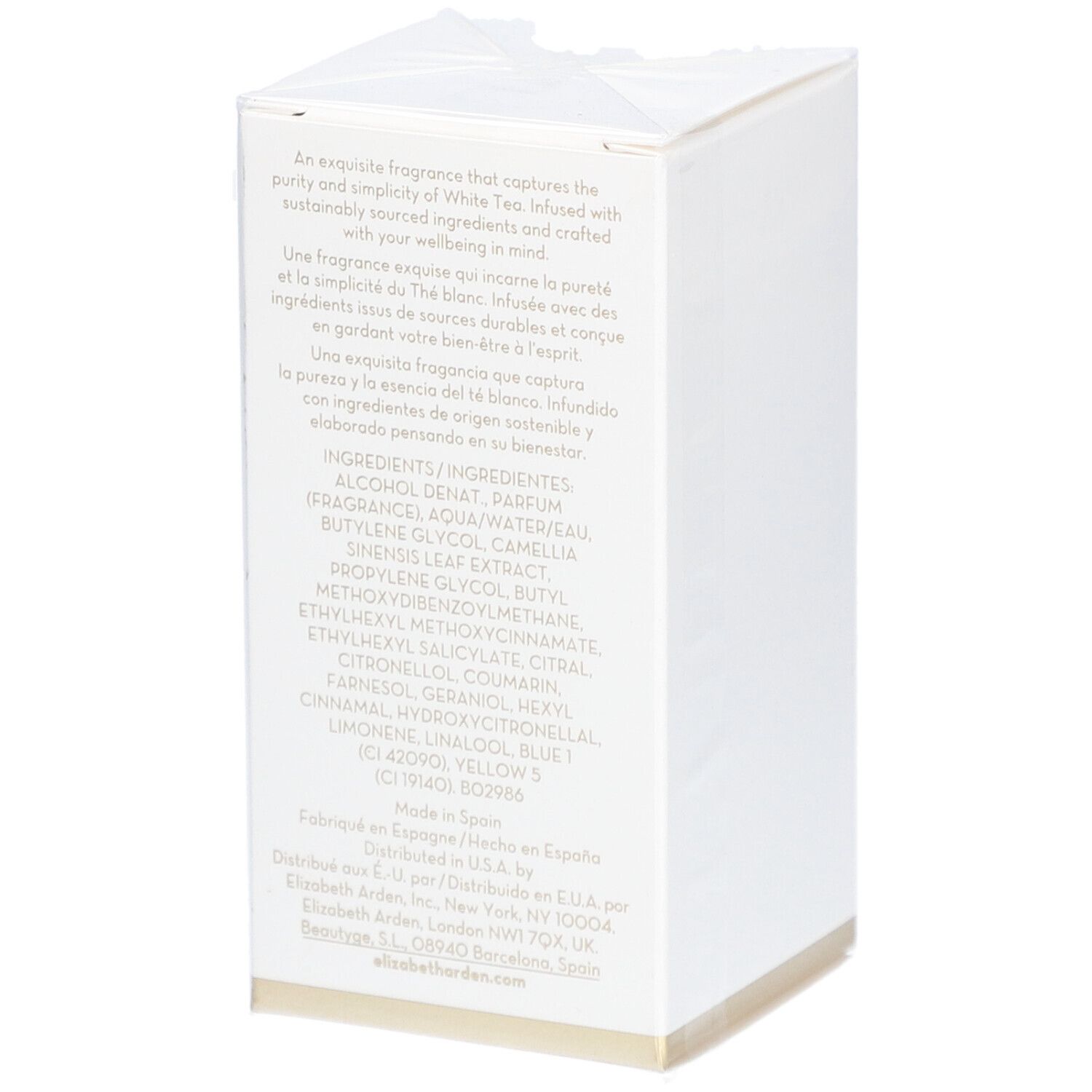Witte rechthoekige doos met tekst. Bevat ingrediënten en fabrikantinformatie. Gouden rand onderaan.