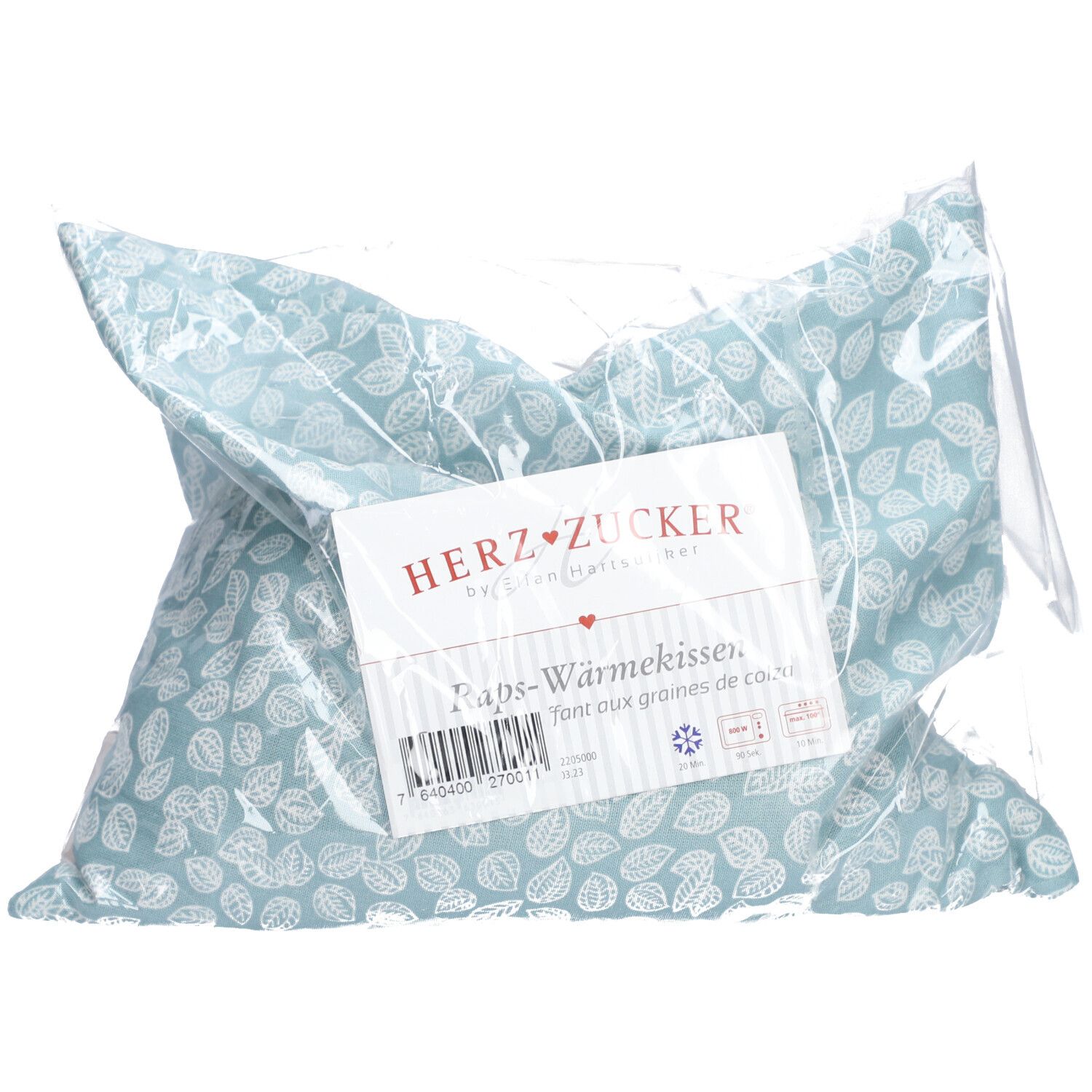 Coussin à motifs de feuilles, emballé dans du plastique. Inscription : HERZZUCKER. Nom du produit : Raps-Wärmekissen.