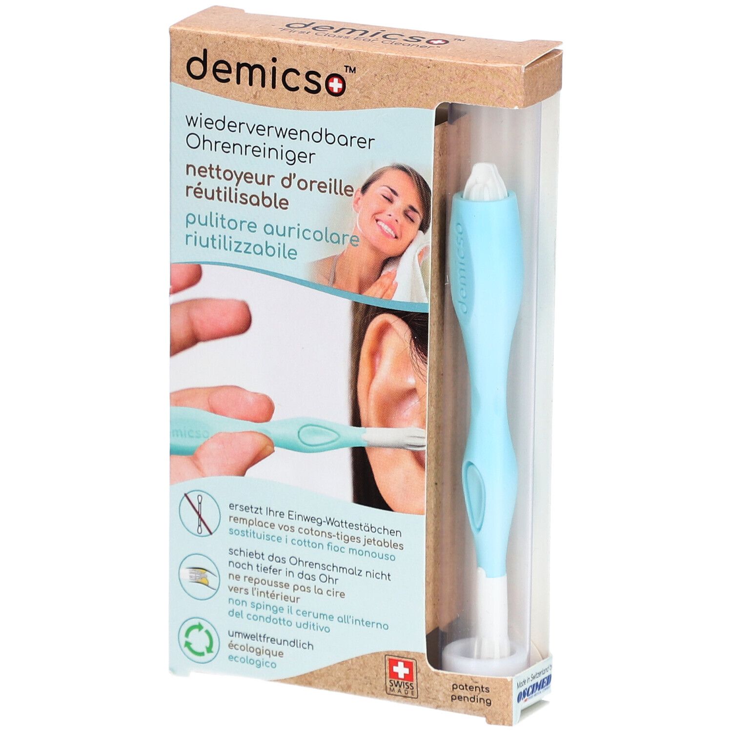 Oorreiniger in verpakking. Lichtblauwe handgreep, witte kop. Productnaam en logo zichtbaar. Transparante verpakking.