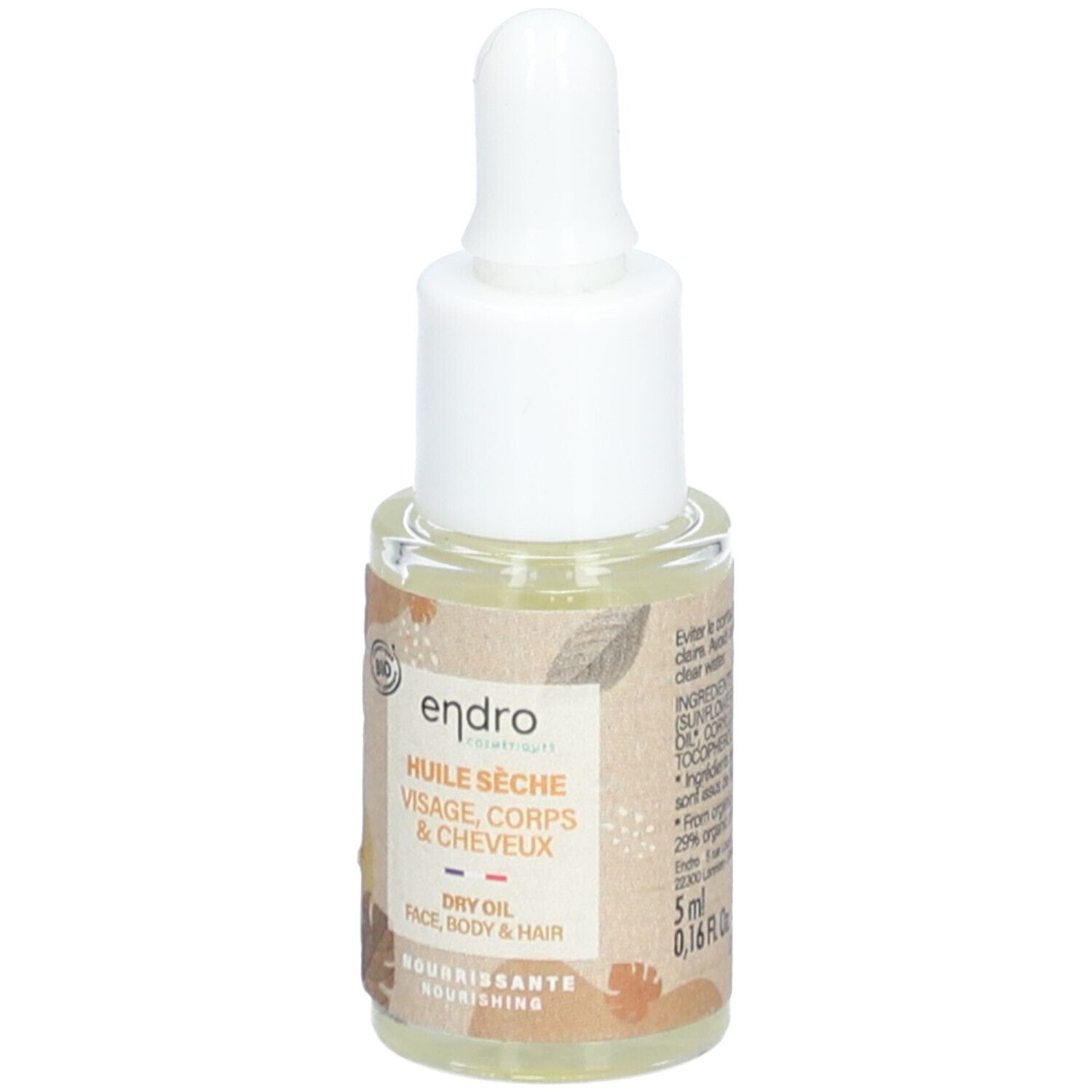 Petite bouteille en verre avec pipette. Étiquette avec informations produit, label bio et volume 5 ml. Texte: Huile Seche, Visage, Corps & Cheveux.