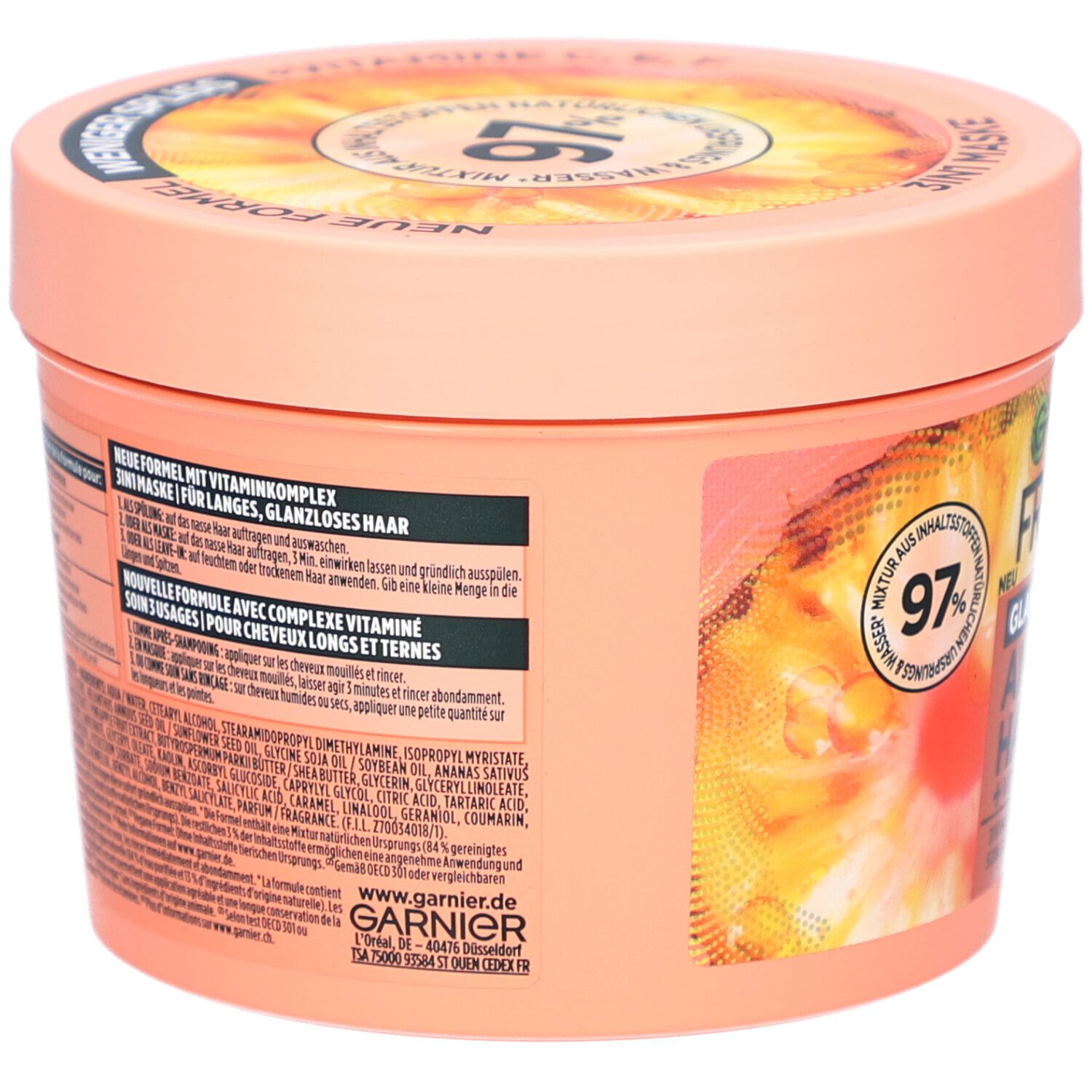 Ronde pot, achterkant, met tekst. Garnier Fructis Hair Food Ananas. Opschrift: Nieuwe formule, met vitaminen.