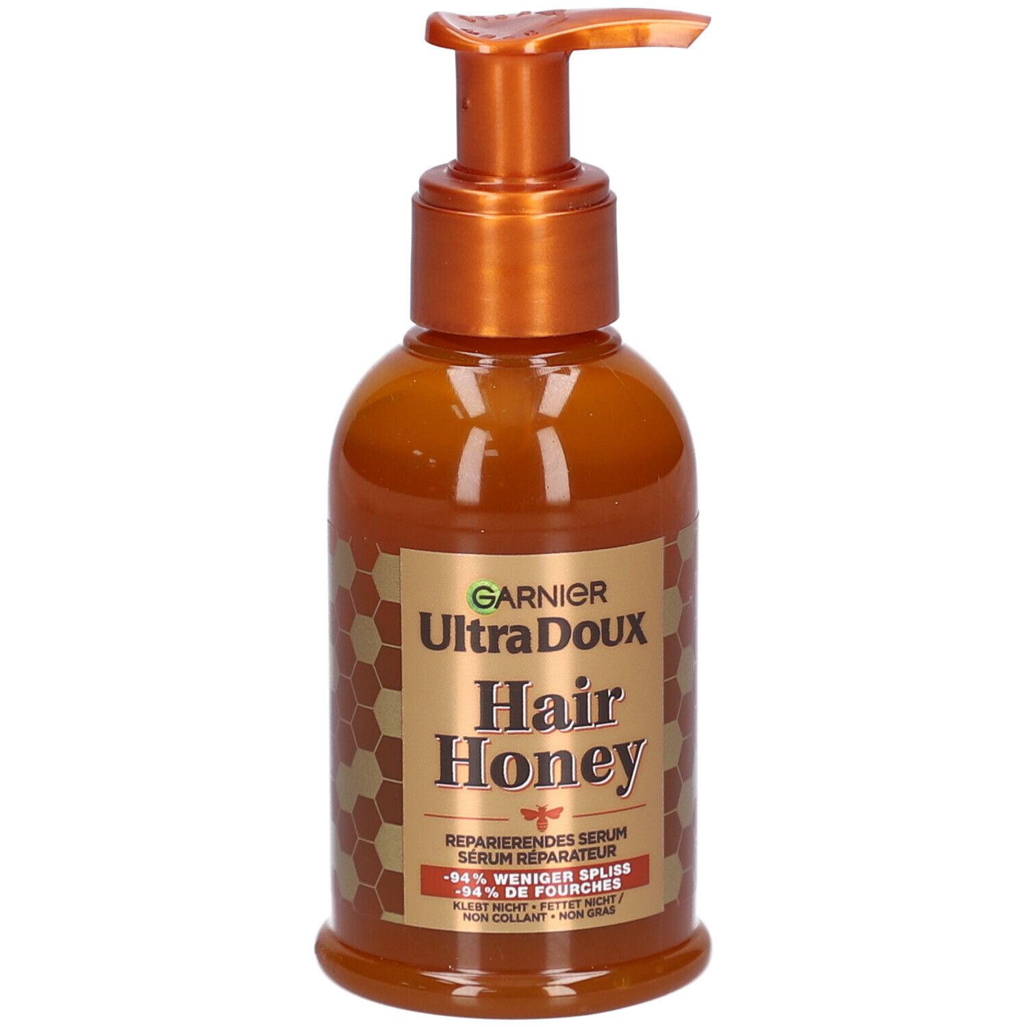 Flacon marron avec pompe. Inscription: Garnier Ultra Doux Hair Honey. Sérum réparateur. Design miel.