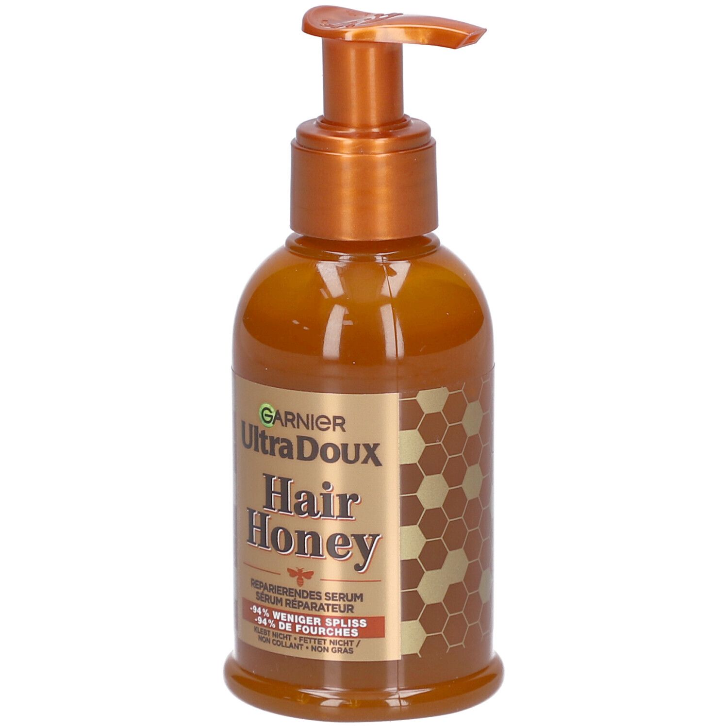 Flacon marron avec pompe. Inscription: Garnier Ultra Doux Hair Honey. Sérum réparateur. Design miel.
