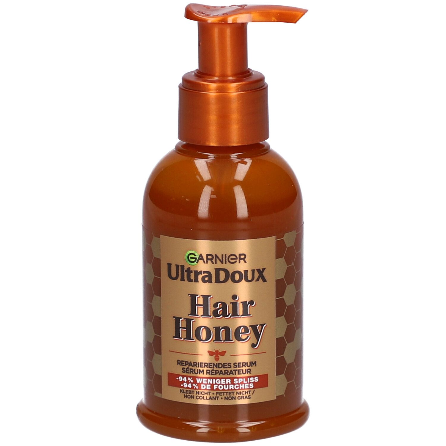 Flacon marron avec pompe. Inscription: Garnier Ultra Doux Hair Honey. Sérum réparateur. Design miel.
