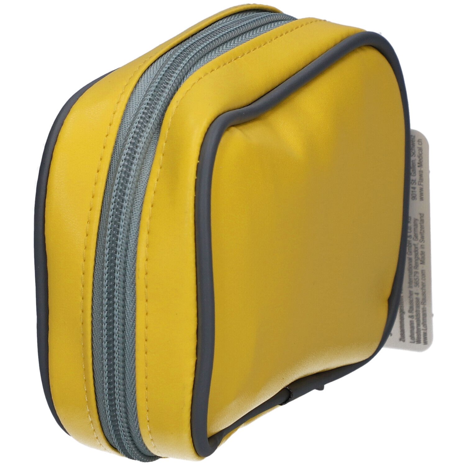 Trousse de premiers secours jaune avec fermeture éclair et bord gris. Fermeture éclair en détail.