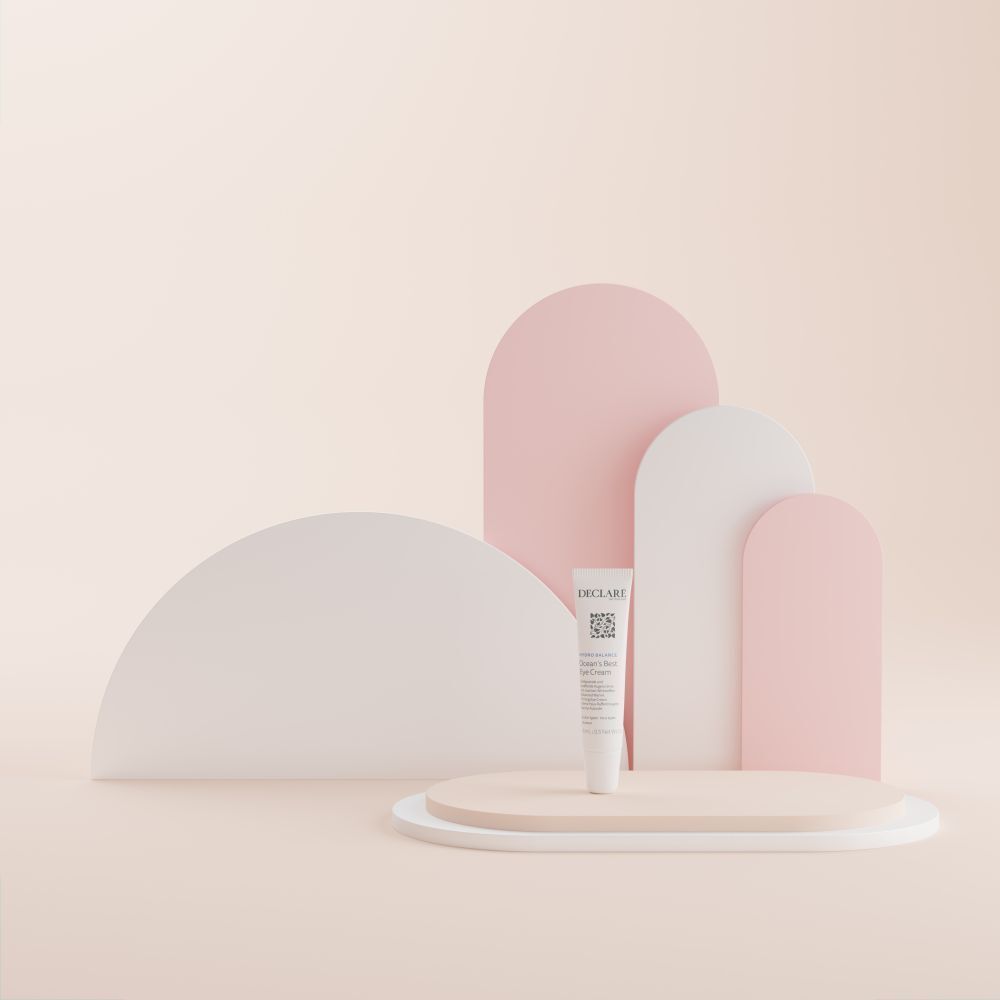 Witte tube op sokkel. Achtergrond: roze en witte vormen. DECLARÉ-logo zichtbaar.