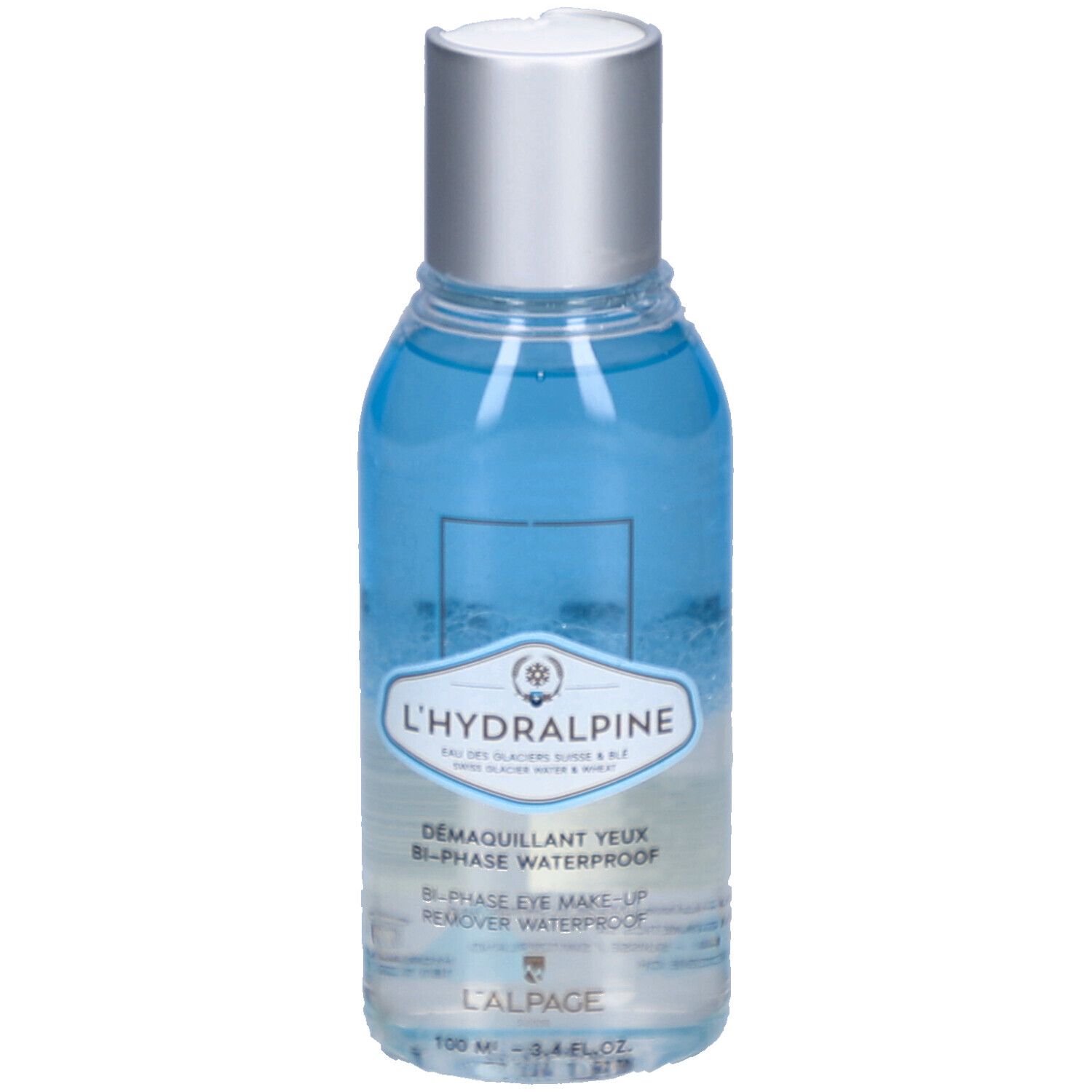 Fles met blauwe en heldere inhoud. Zilveren dop. Opschrift: L'Hydralpine, Démaquillant Yeux Bi-Phase Waterproof.