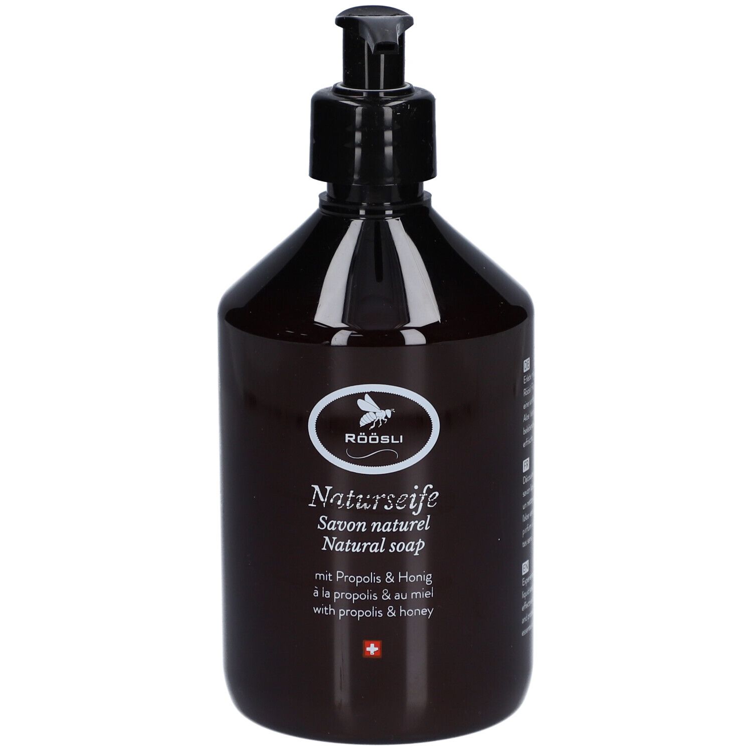 Bruine fles met zwarte pomp. Opschrift: RÖÖSLI Naturseife, Savon naturel, Natural soap. Met Propolis & Honing.