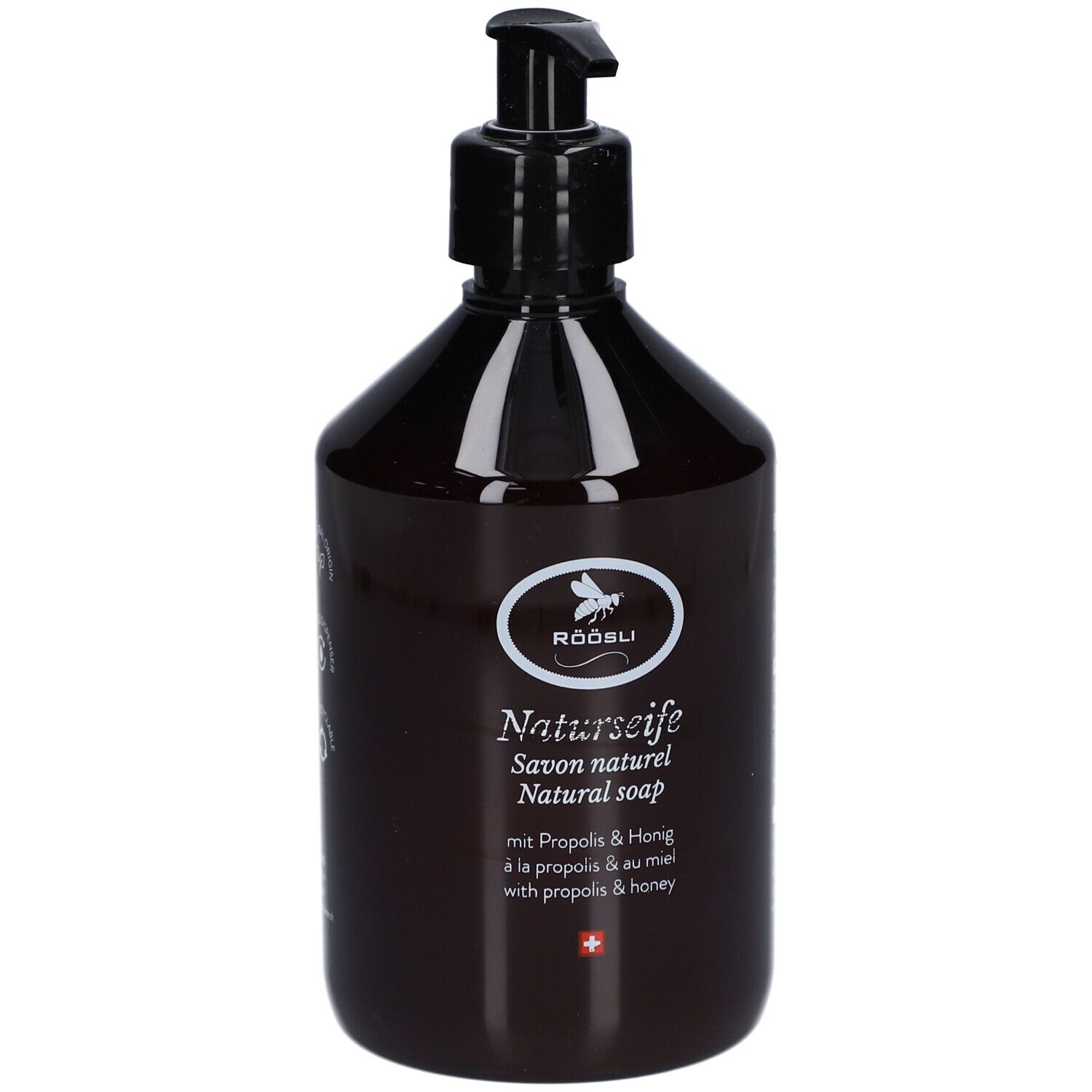 Bruine fles met zwarte pomp. Opschrift: RÖÖSLI Naturseife, Savon naturel, Natural soap. Met Propolis & Honing.