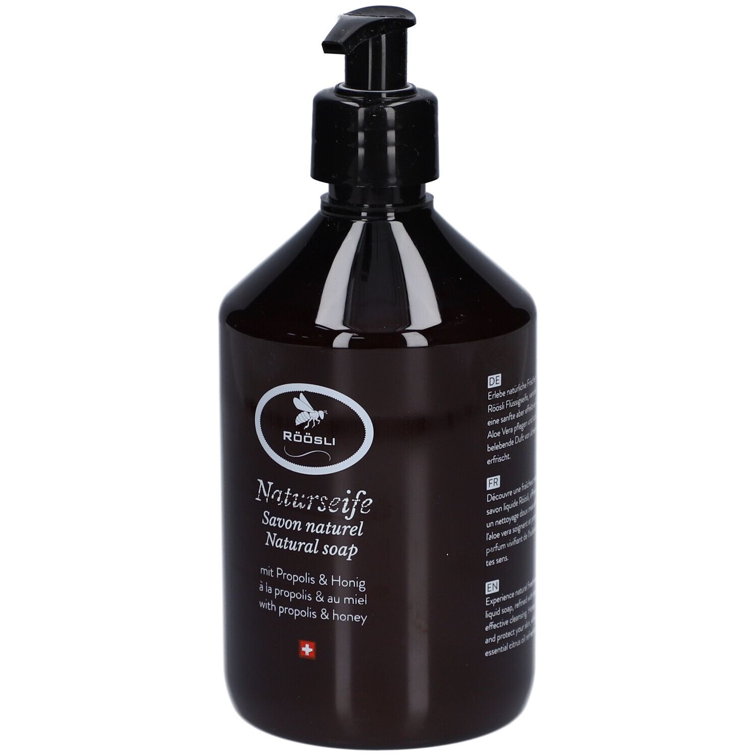 Bruine fles met zwarte pomp. Opschrift: RÖÖSLI Naturseife, Savon naturel, Natural soap. Met Propolis & Honing.