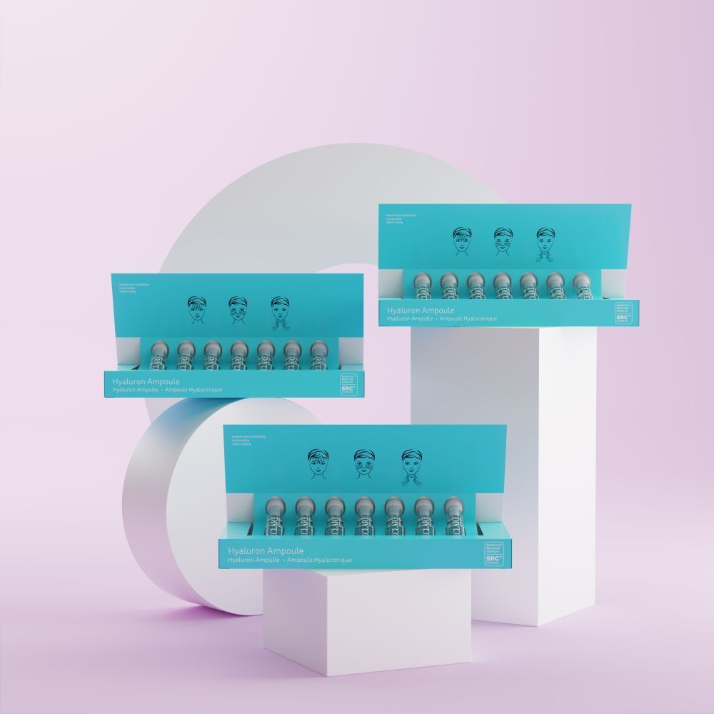 Trois boîtes d'ampoules DECLARÉ Hyaluron. Placées sur un fond rose et blanc. Chaque boîte contient des ampoules.