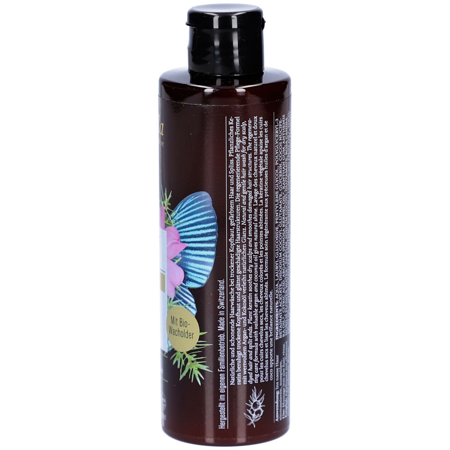 Flacon de shampooing brun, vue latérale. Inscription : Nutri Repair Shampoo, Phyto Keratin. Avec genièvre bio. Fabriqué en Suisse.