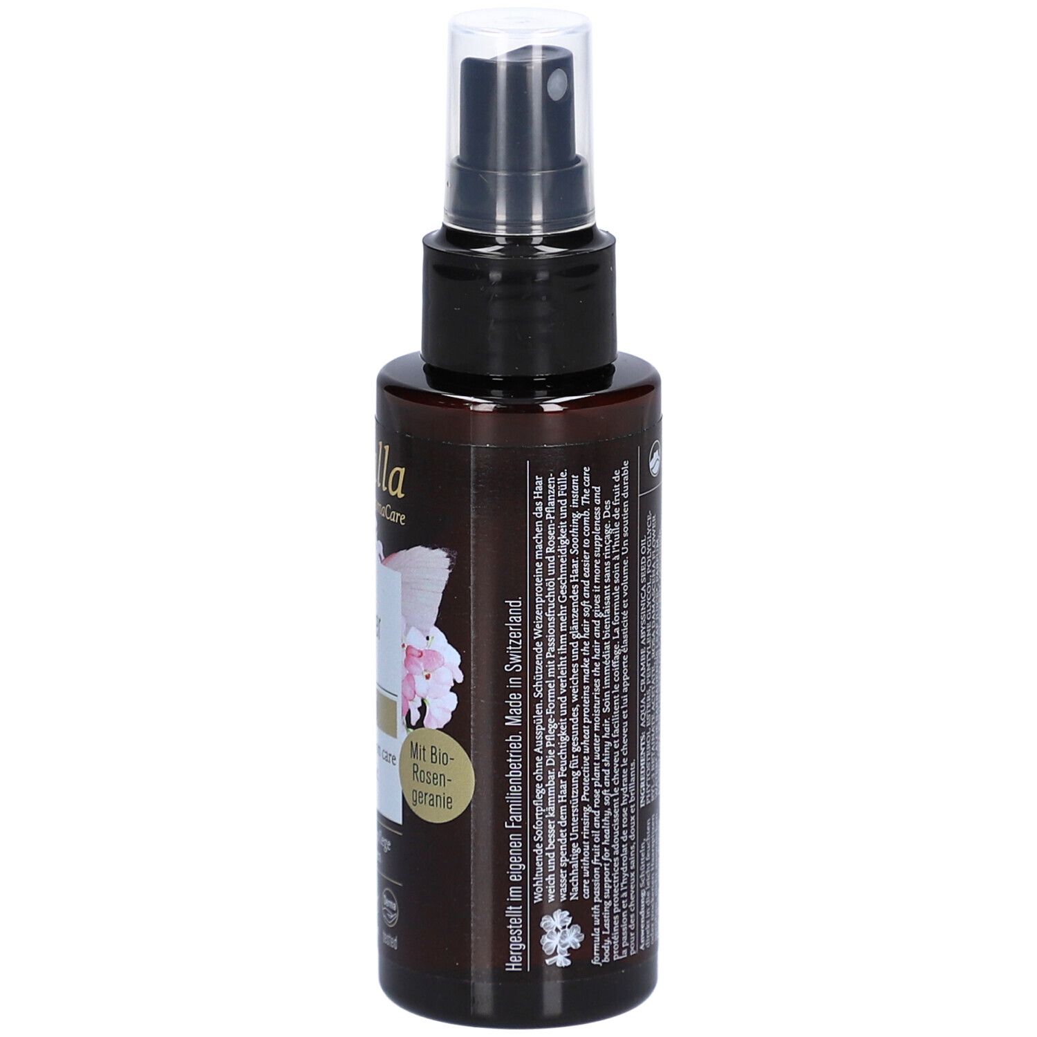 Bruine sprayfles met zwarte sproeikop. Achterkant met tekst. Opschrift: gemaakt in Zwitserland.