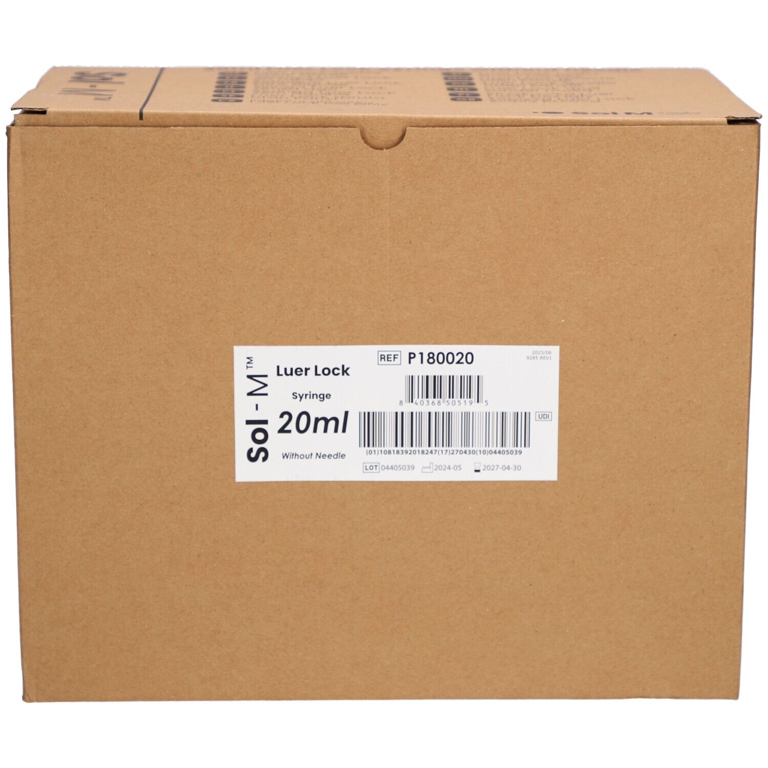 Boîte en carton avec étiquette. Inscription: Sol-M Luer Lock Seringue 20ml sans aiguille. Référence et code-barres.