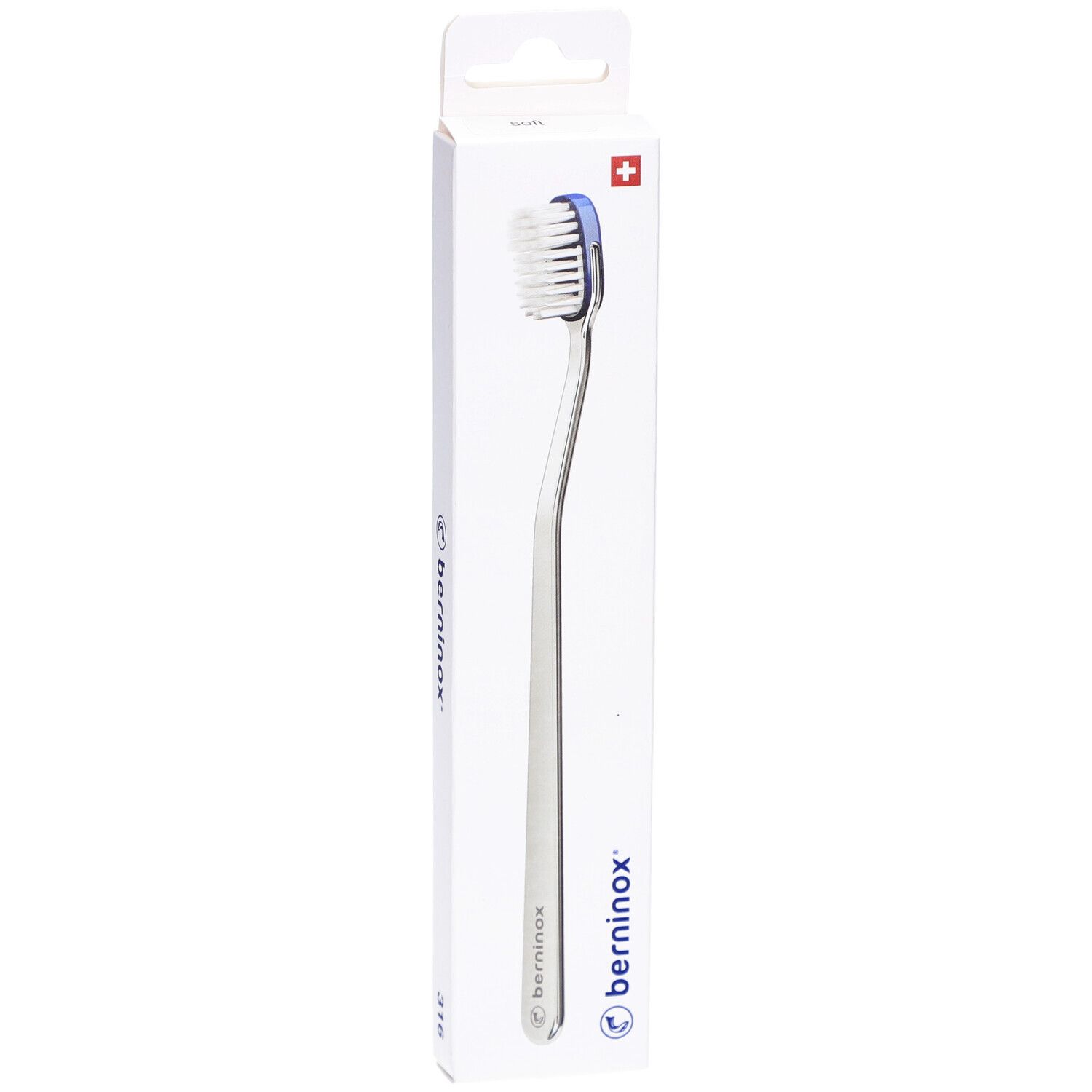Brosse à dents dans son emballage. Tête blanche, bord bleu, manche argenté. Emballage avec logo et croix suisse.