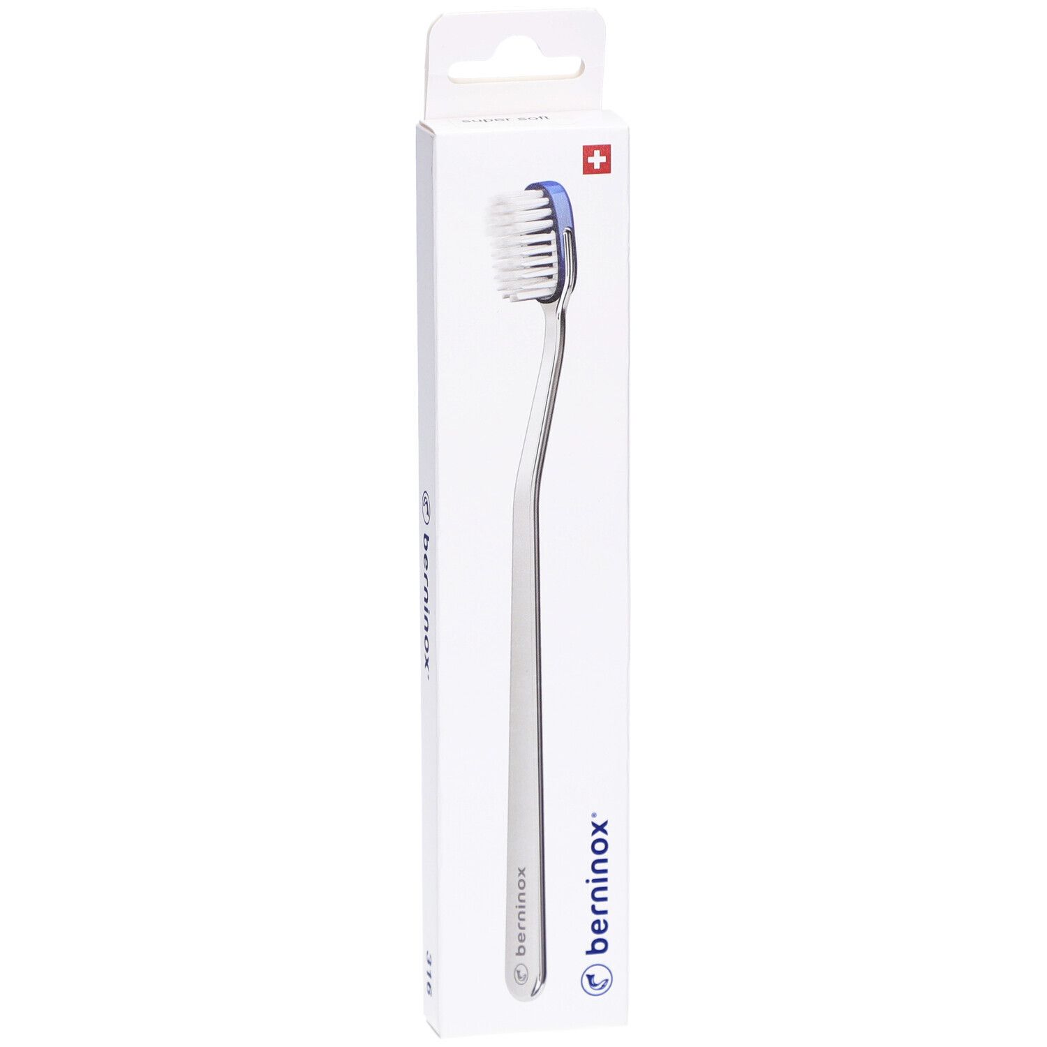 Brosse à dents dans son emballage. Boîte blanche avec nom du produit et croix suisse. Brosse à bord bleu.