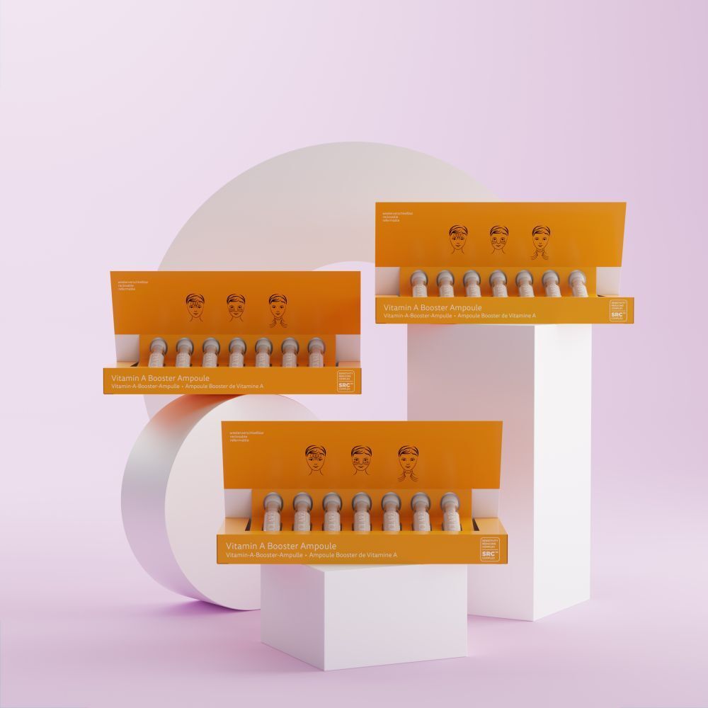 Drie gele dozen DECLARÉ Vitamin A Booster Ampulle. Roze tekst "VITAMIN". Elke doos bevat ampullen.