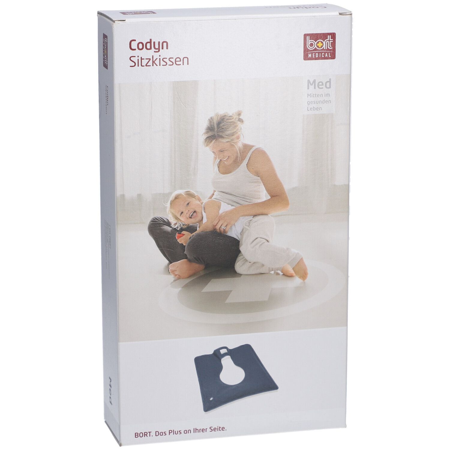 Emballage du coussin Codyn. Inscriptions : nom du produit, logo, image d'une femme avec un enfant. Coussin bleu au premier plan.