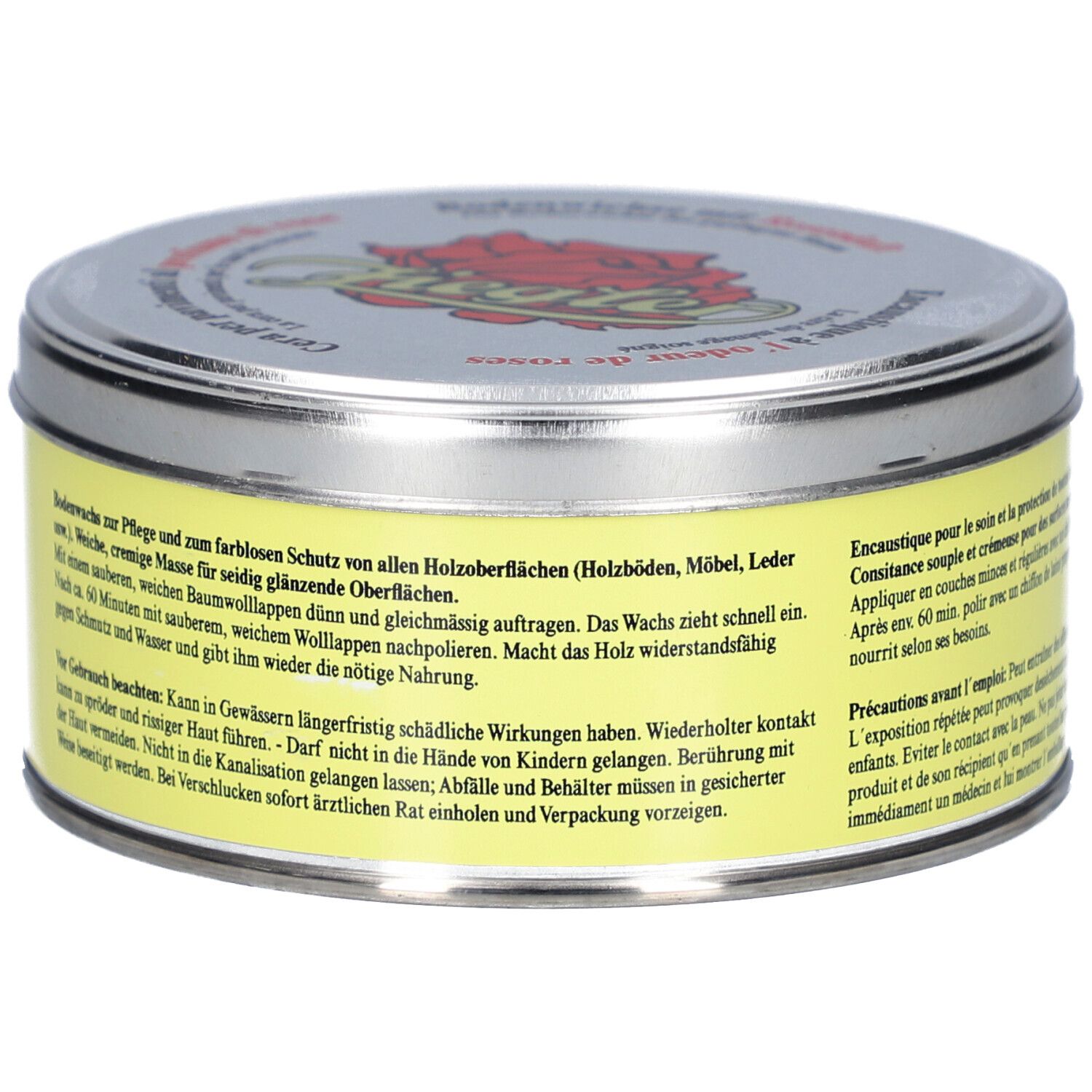 Boîte ronde avec étiquette jaune et texte. Couvercle argenté avec logo et texte. Nom du produit non visible.