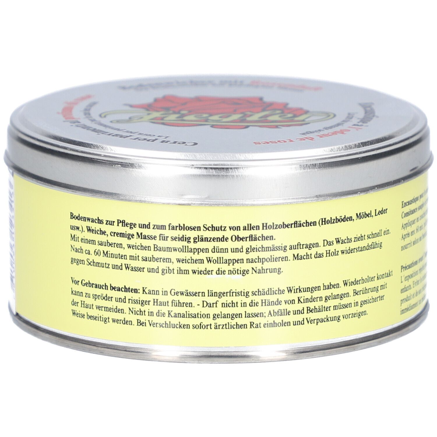 Boîte ronde avec étiquette jaune et texte. Couvercle argenté avec logo et texte. Nom du produit non visible.
