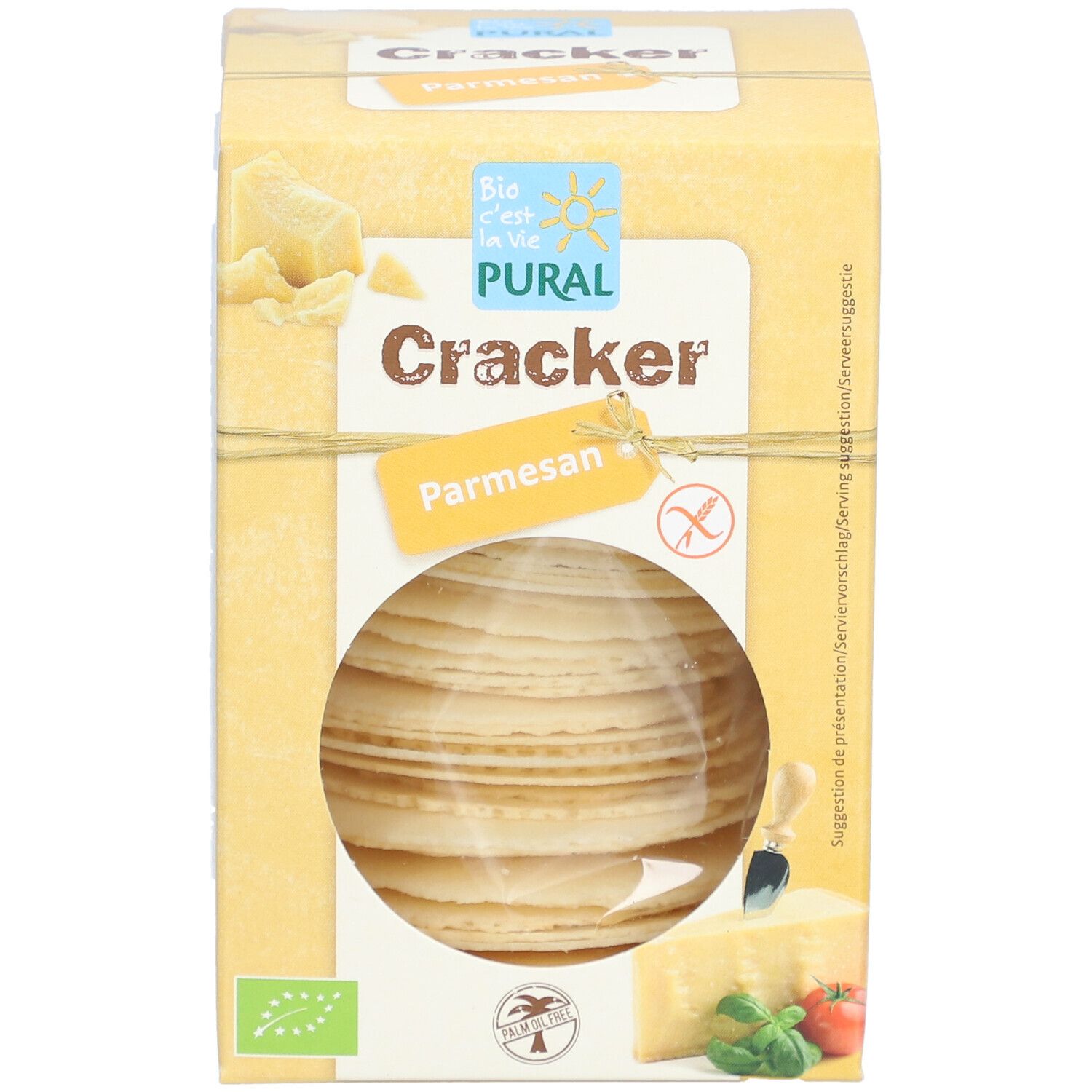 Boîte jaune "PURAL Cracker Parmesan". Fenêtre ronde montrant des crackers. Labels bio et sans gluten.