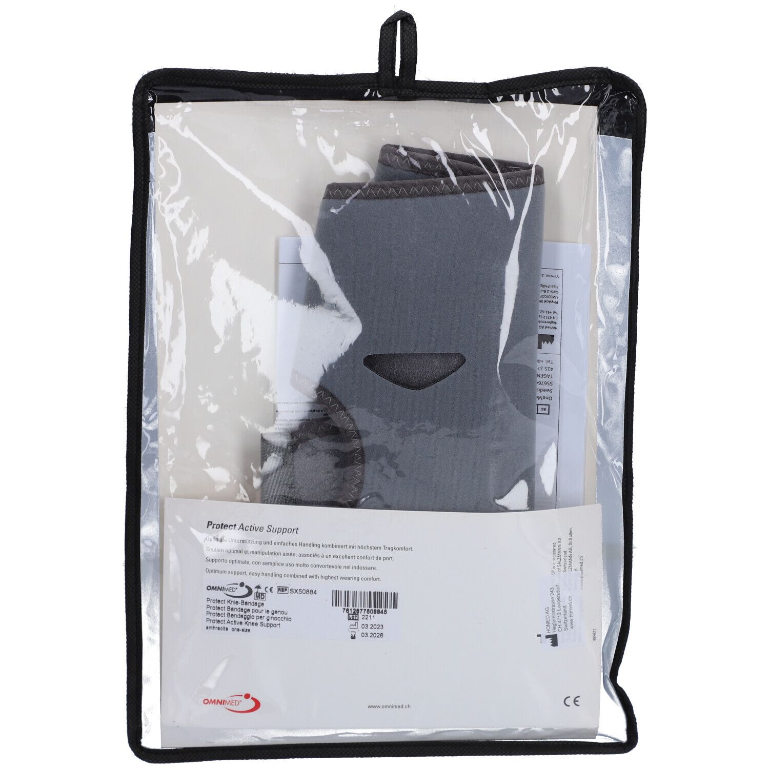 OMNIMED bandage genou dans emballage. Sac noir avec bandage et documents. Bandage gris, avec découpe.