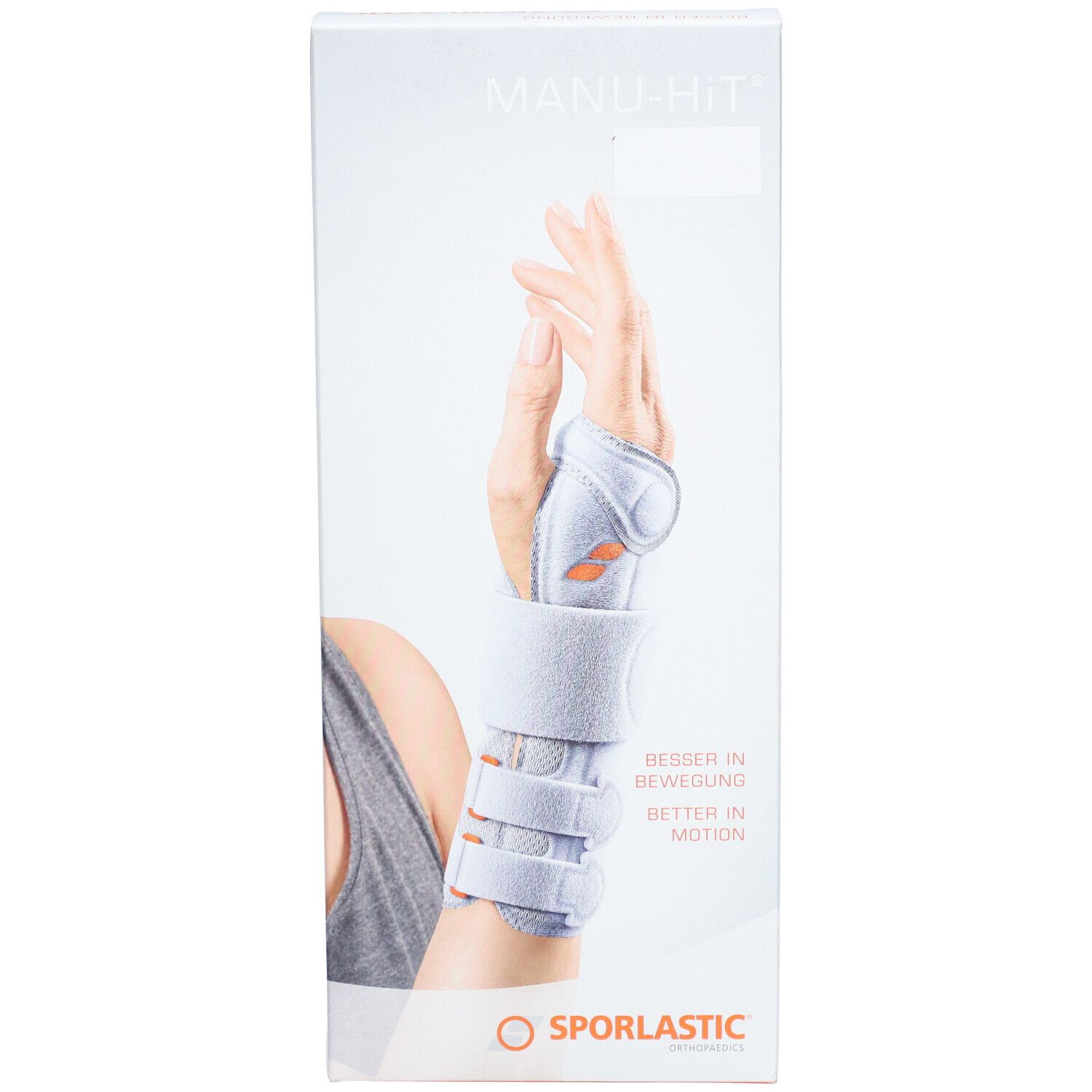Verpakking van de polsbrace. Opschrift: MANU-HIT, SPORLASTIC. Afbeelding: hand met brace.