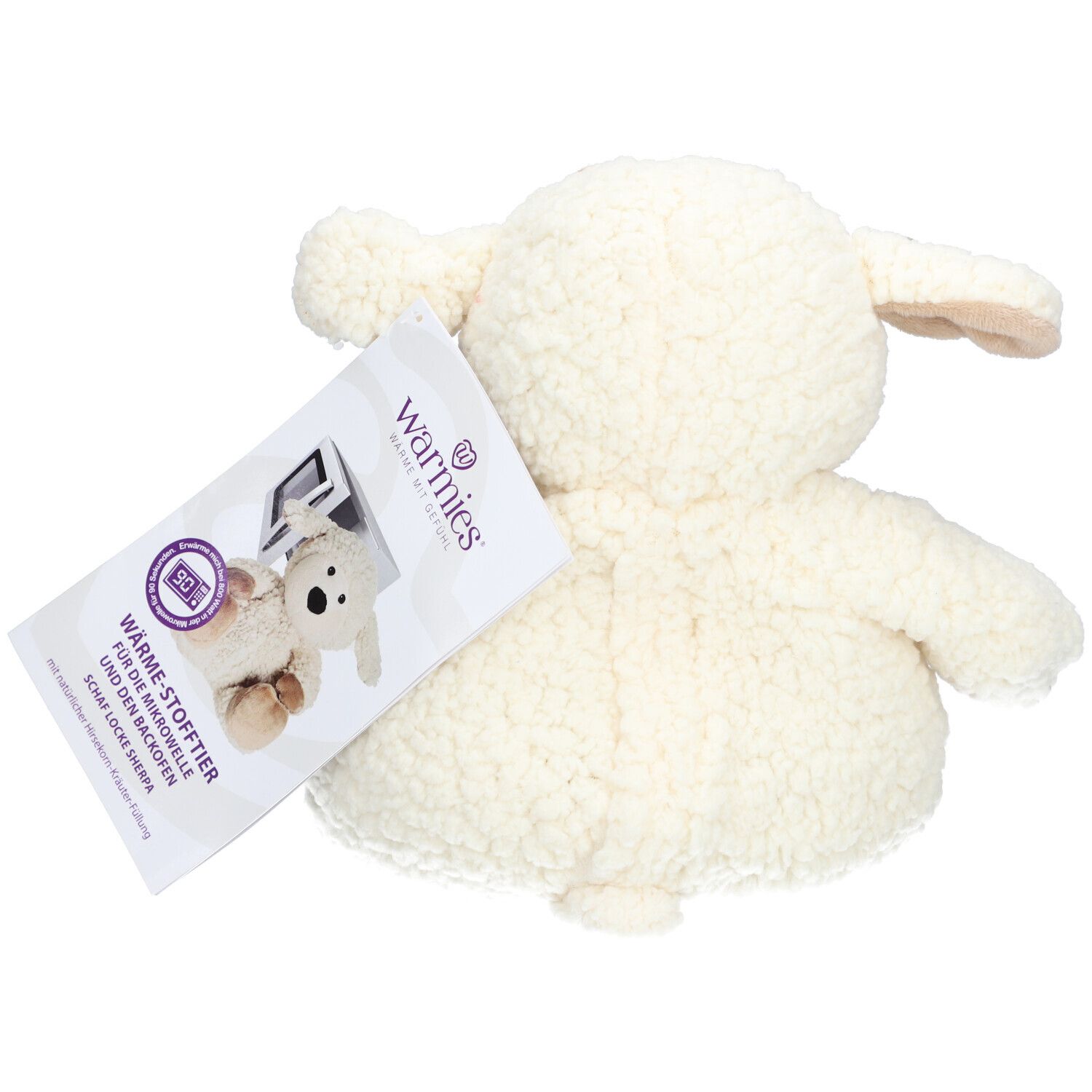 Vue arrière du mouton en peluche blanc. Étiquette avec informations produit et logo.