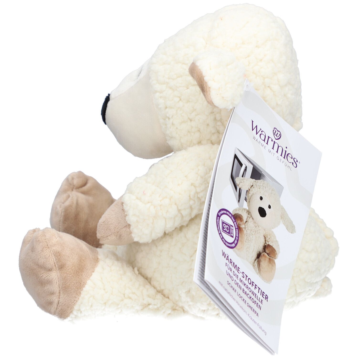 Vue latérale du mouton en peluche blanc. Étiquette avec informations produit et logo.