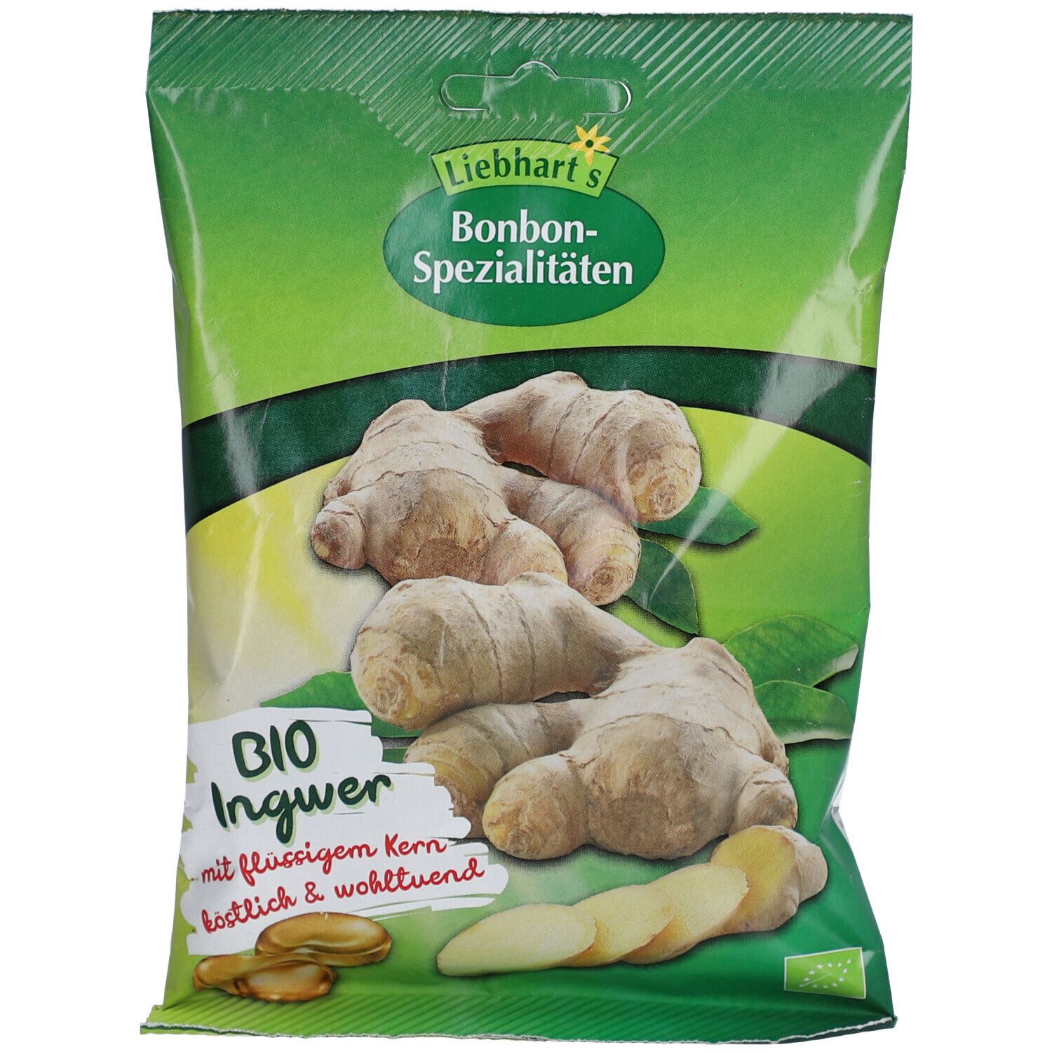 Emballage de bonbons bio au gingembre, fourrés d'un cœur liquide. Racines de gingembre fraîches représentées.