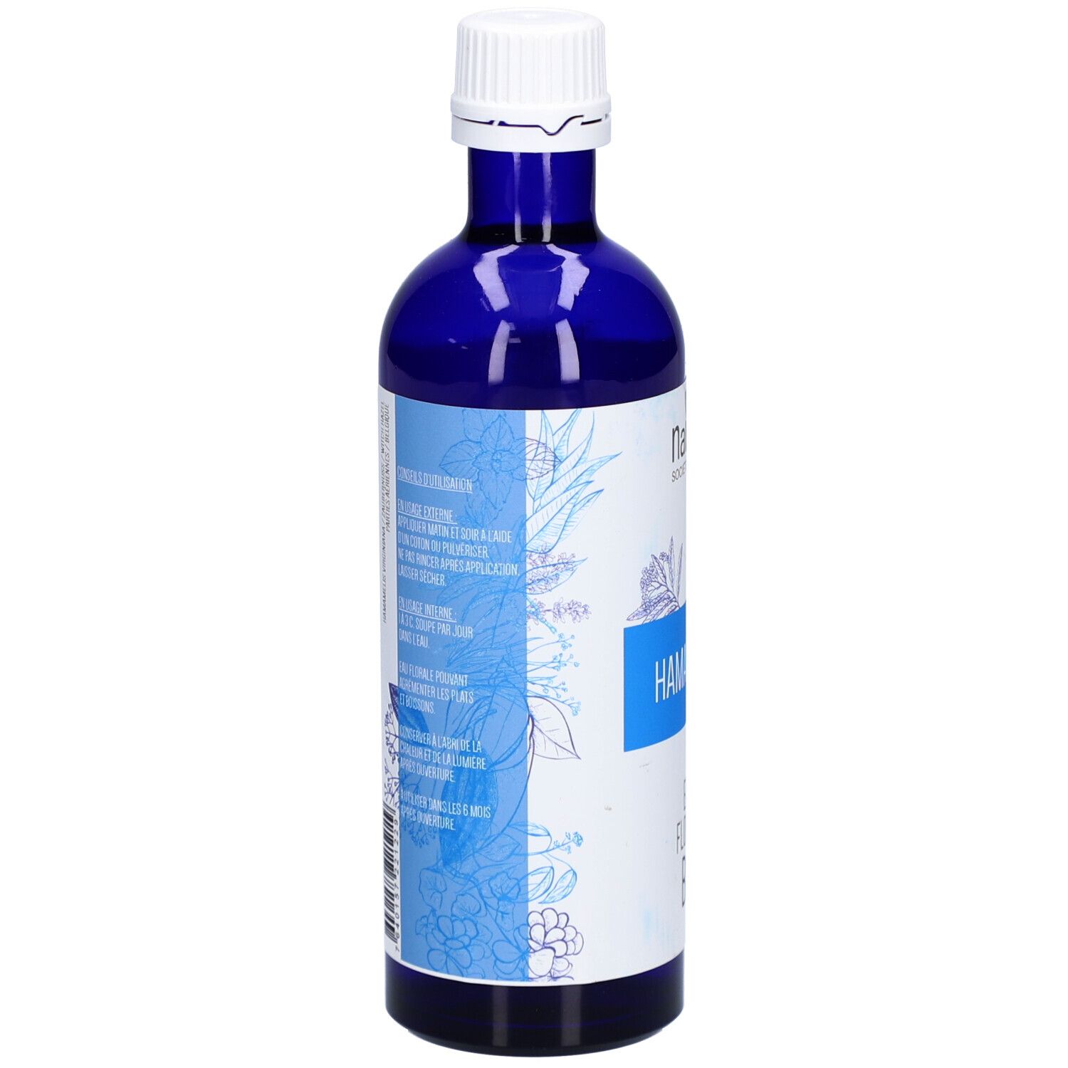 Flacon en verre bleu. Inscription: HAMAMÉLIS, EAU FLORALE BIO. Texte multilingue. Motif floral.