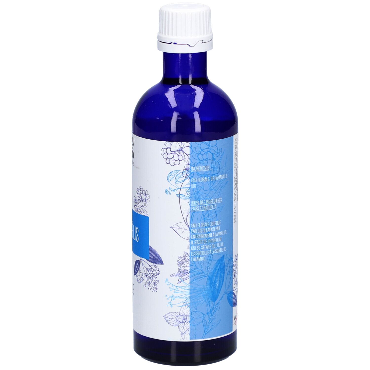Flacon en verre bleu. Inscription: HAMAMÉLIS, EAU FLORALE BIO. Texte multilingue. Motif floral.