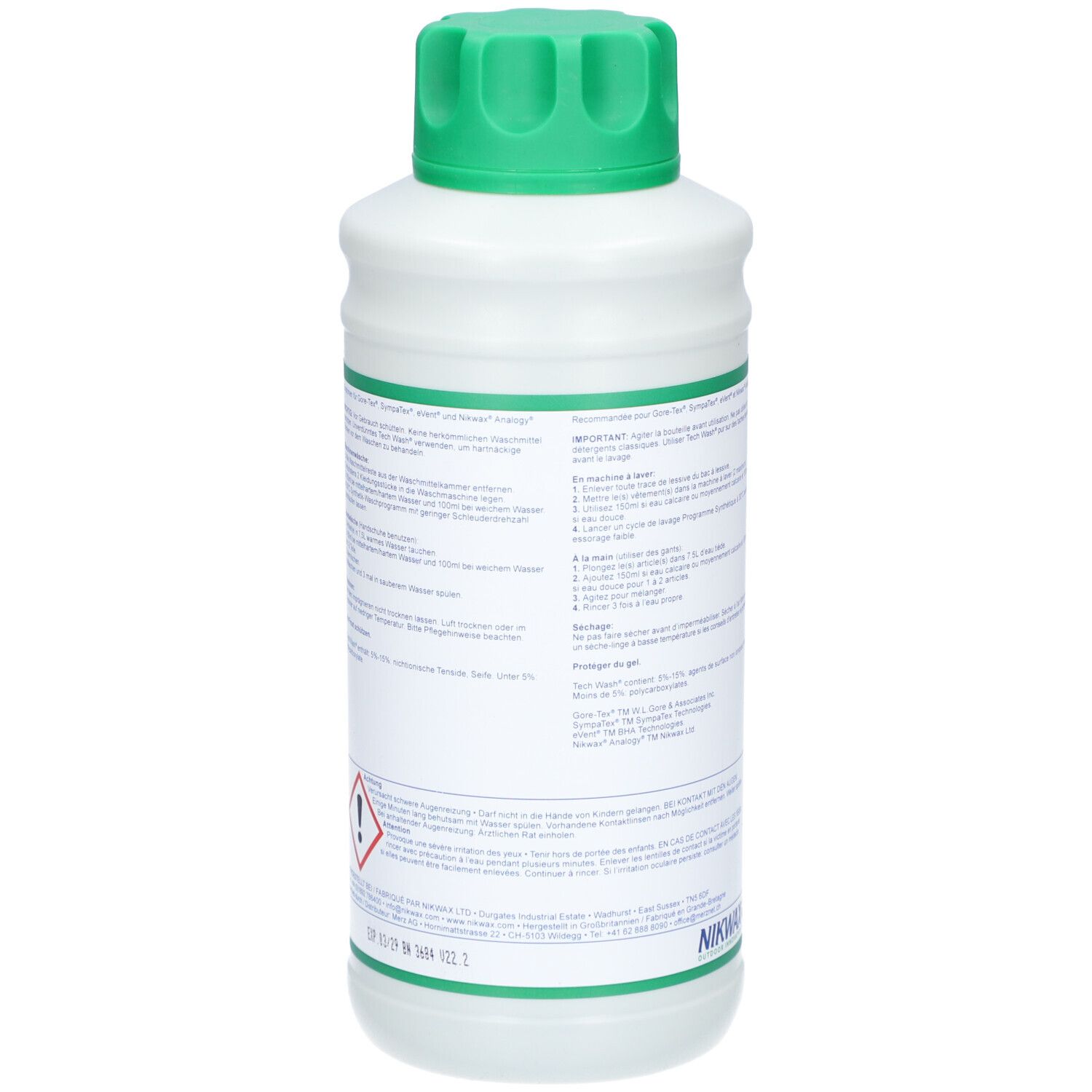 Achterkant van de witte fles met groene dop. Tekst in meerdere talen. Gevaarsymbool. Fles staat.