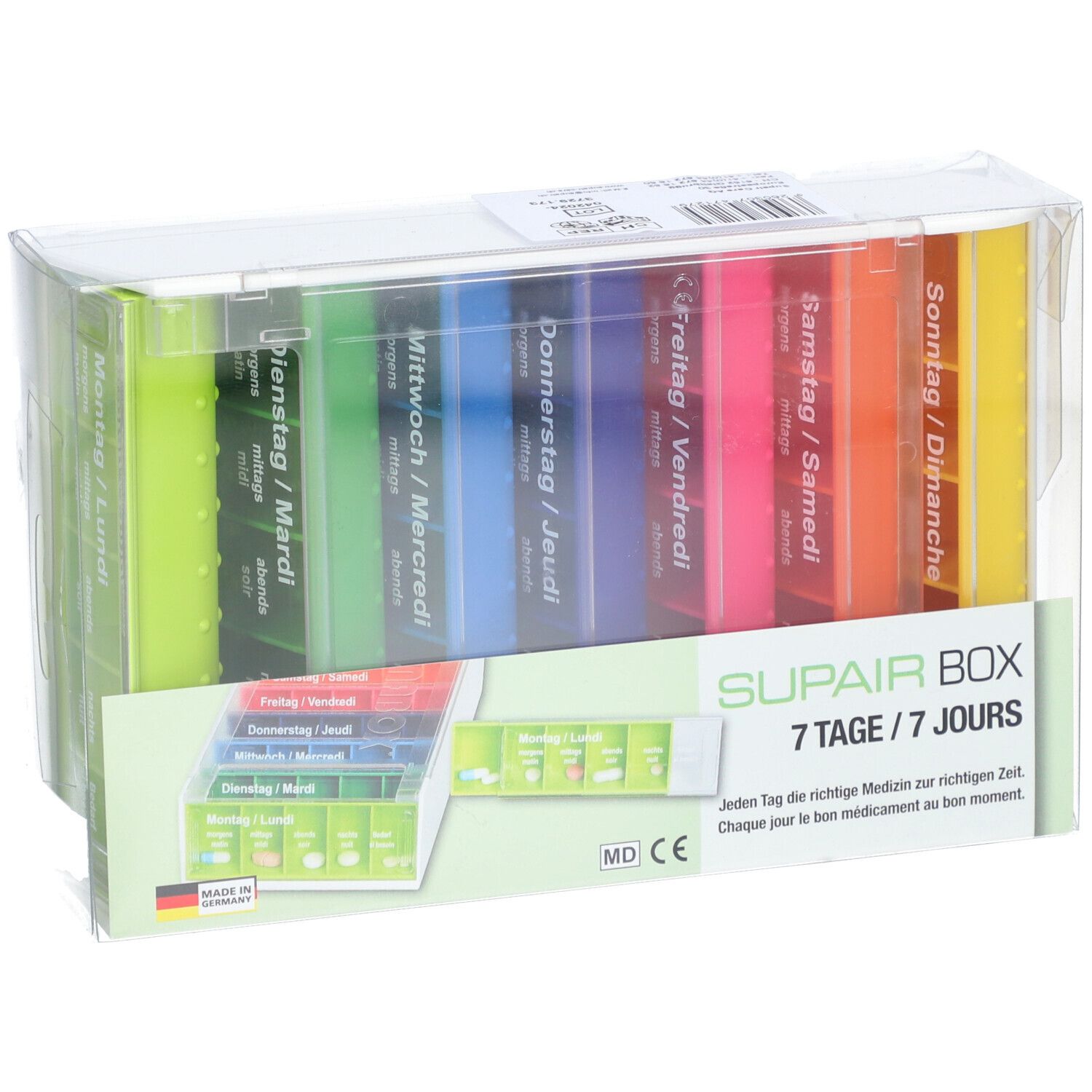 SUPAIRBOX Semainier Rainbow. Boîte à pilules 7 jours avec compartiments colorés. Emballé dans du plastique transparent. Avec texte allemand.