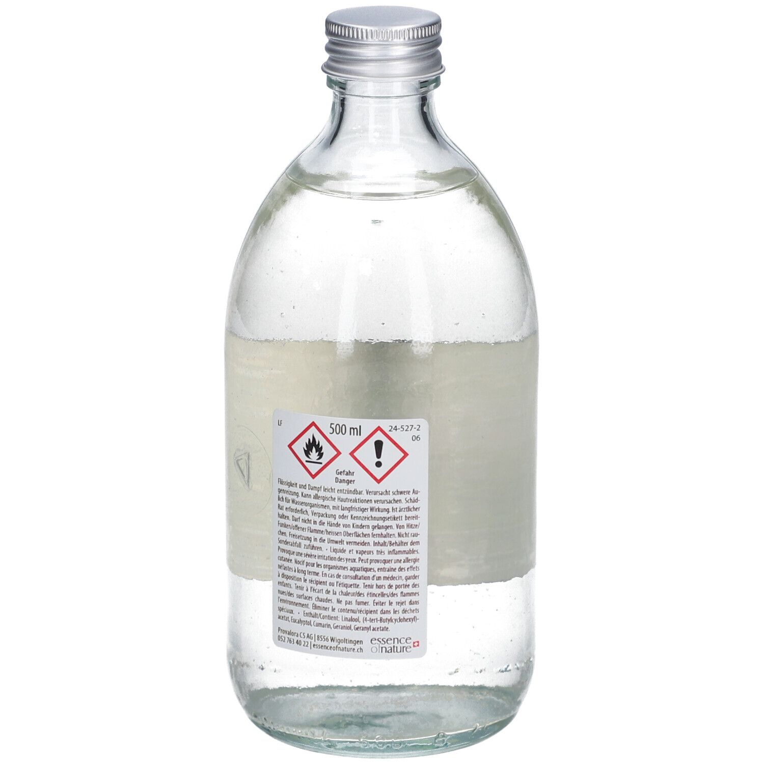 Glazen fles met zilveren dop. Etiket met waarschuwingssymbolen en tekst. 500 ml.