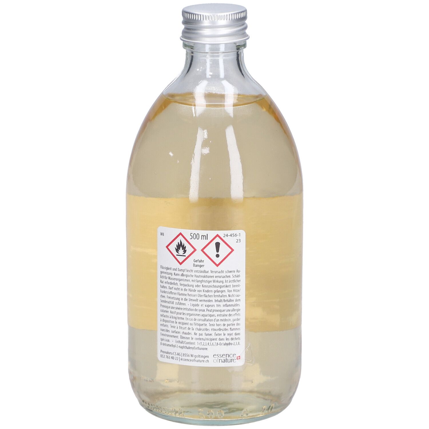 Flacon en verre avec bouchon argenté. Dos avec étiquette, texte et pictogrammes. 500 ml.
