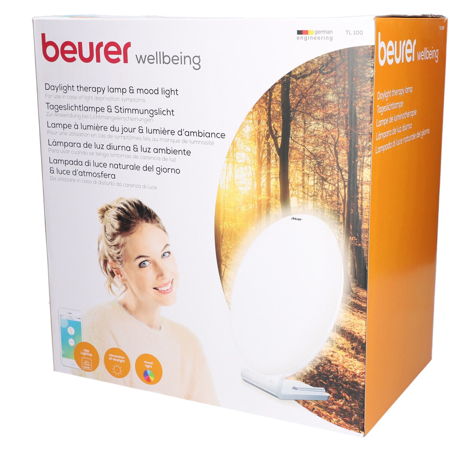 Beurer TL 100 verpakking. Opdruk: Daglichttherapielamp & sfeerverlichting. Vrouw met smartphone. Productafbeelding.