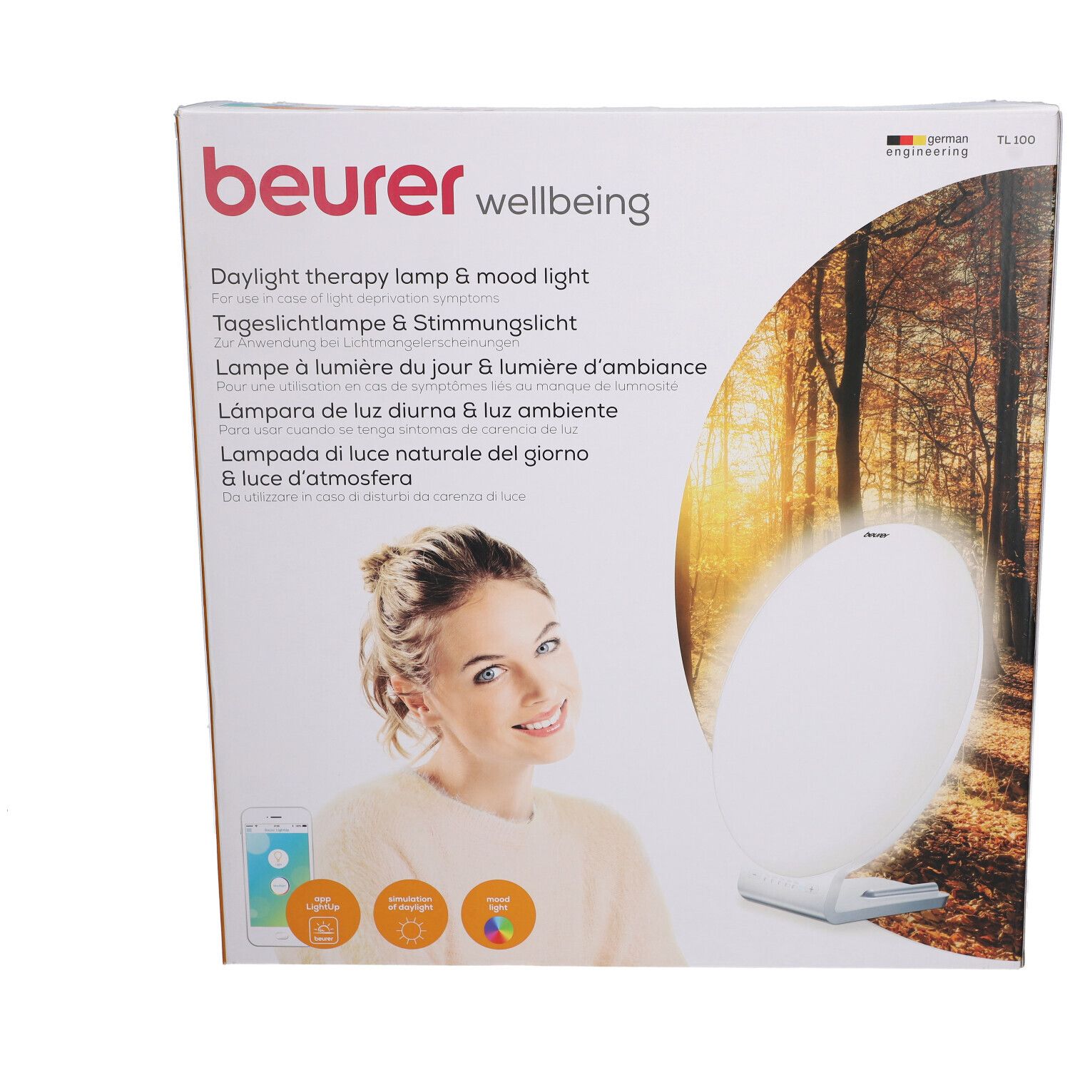 Beurer TL 100 verpakking. Opdruk: Daglichttherapielamp & sfeerverlichting. Vrouw met smartphone. Productafbeelding.