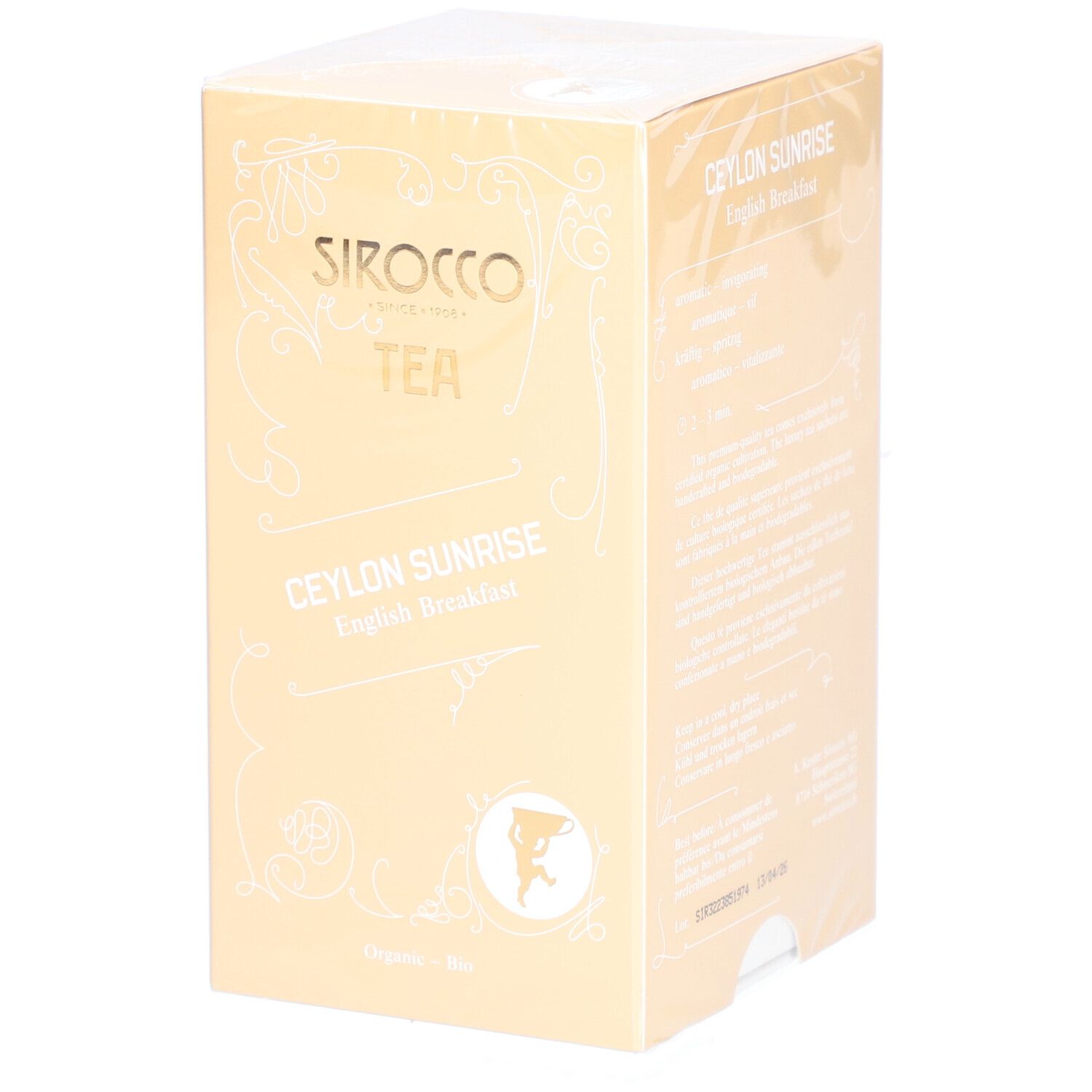 Verpakking van Sirocco thee. Opschrift: Ceylon Sunrise English Breakfast. Gouden doos met witte tekst en logo.