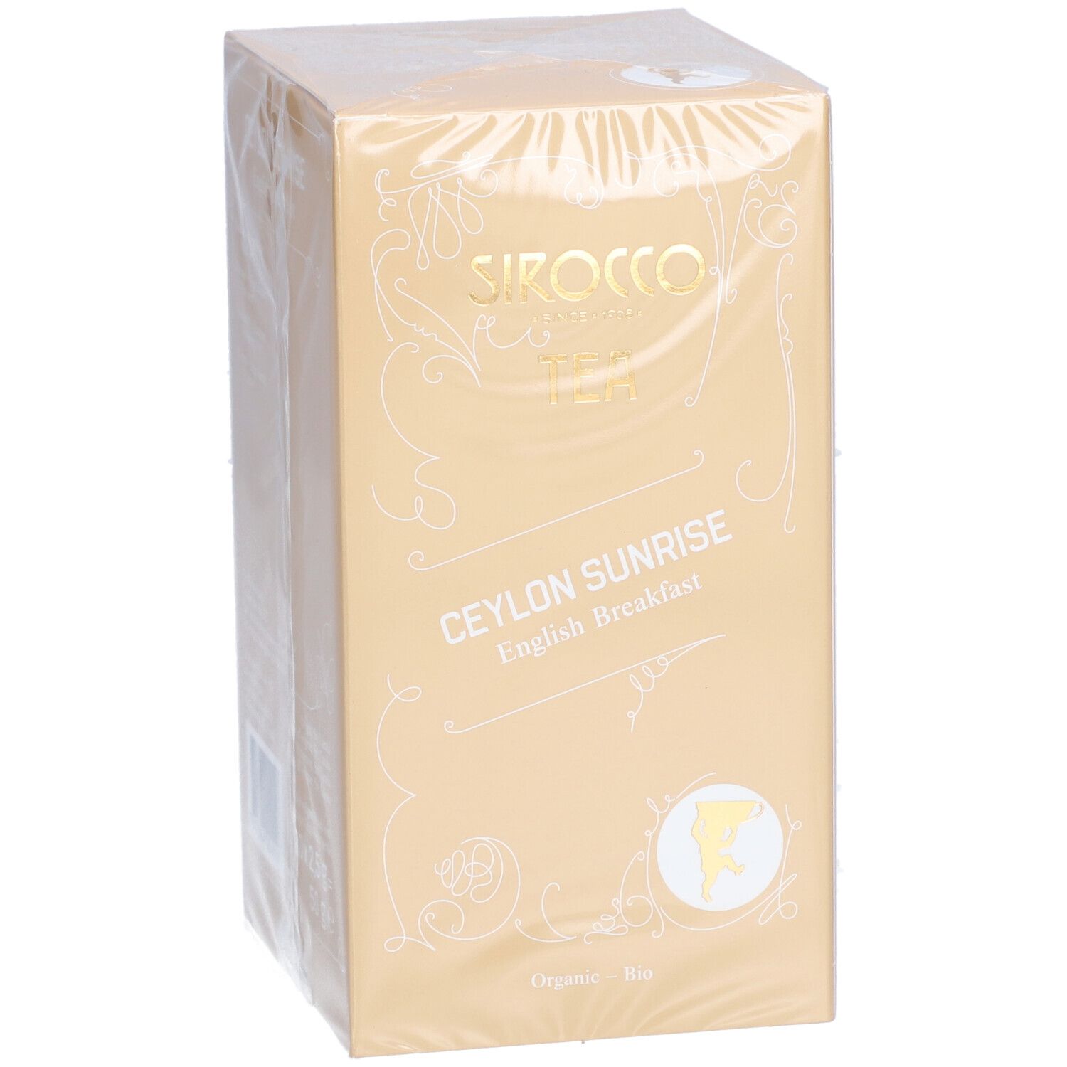 Verpakking van Sirocco thee. Opschrift: Ceylon Sunrise English Breakfast. Gouden doos met witte tekst en logo.