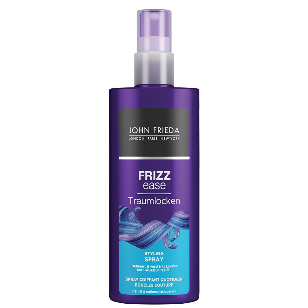 Fles JOHN FRIEDA Frizz ease Traumlocken Styling Spray. Paarse fles met verstuiver. Tekst: Frizz ease, Traumlocken, Styling Spray.