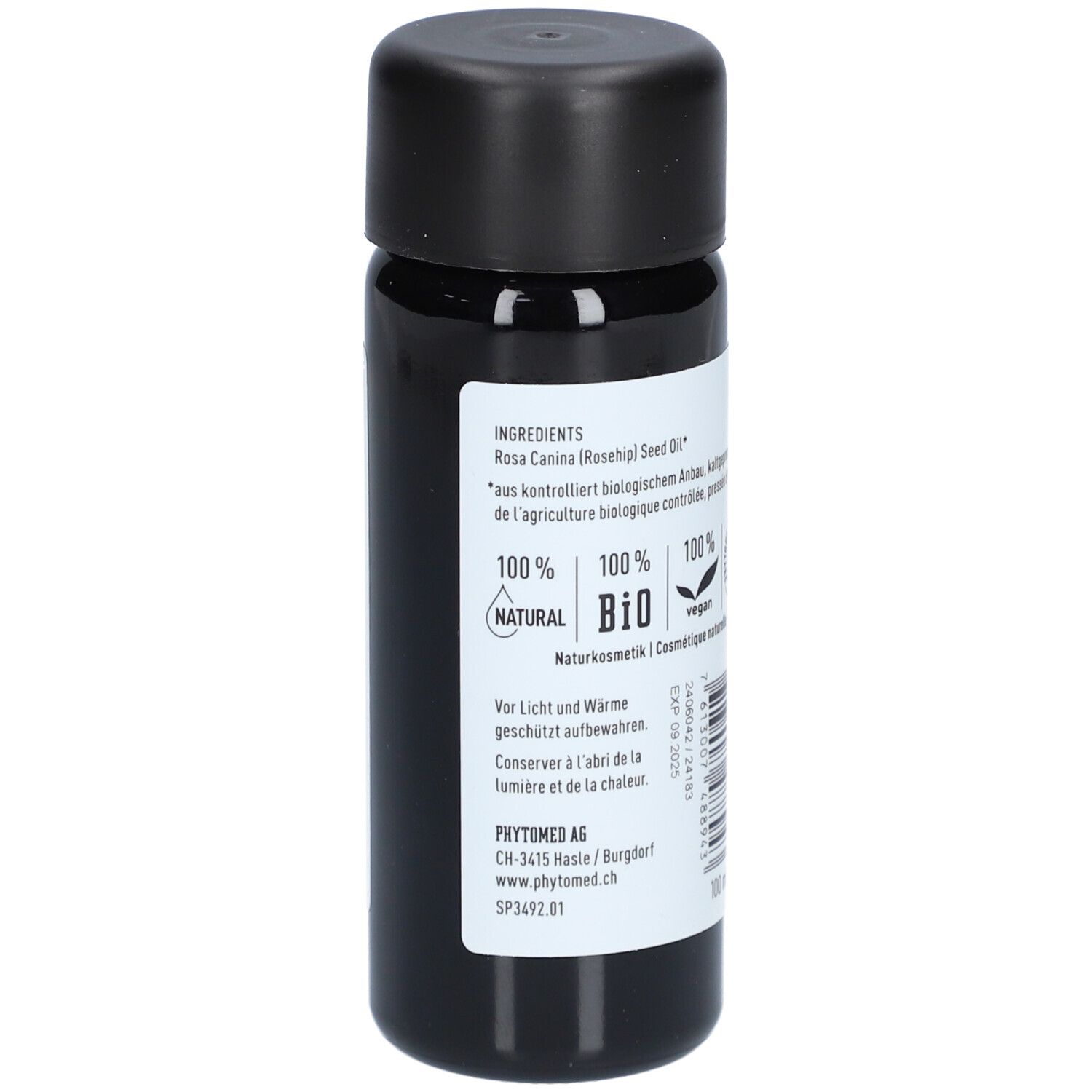Zijaanzicht van de biologische rozenbottelpitolie fles met ingrediëntenlijst.