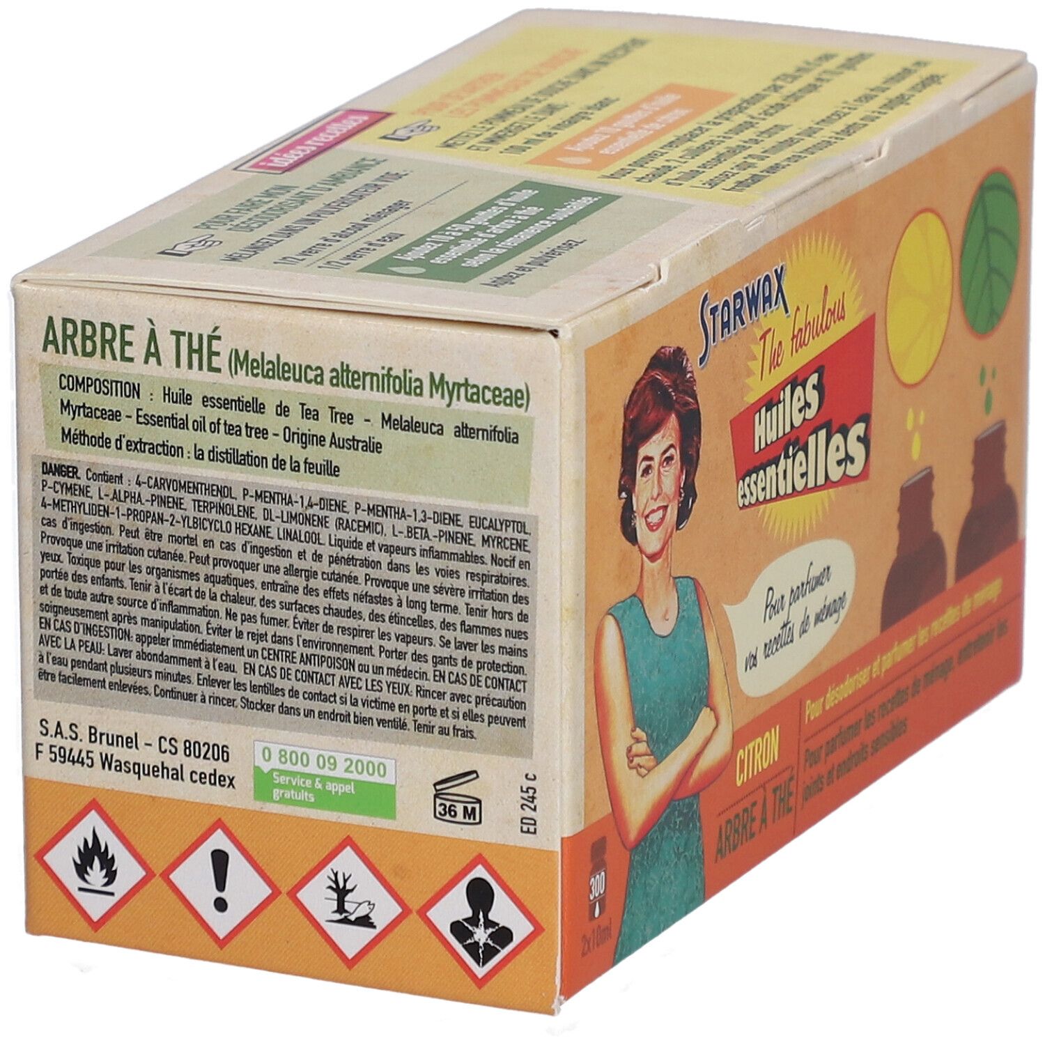Emballage en carton avec informations sur le produit. Inscription : Arbre à thé, Huiles essentielles. Symboles de danger et ingrédients.